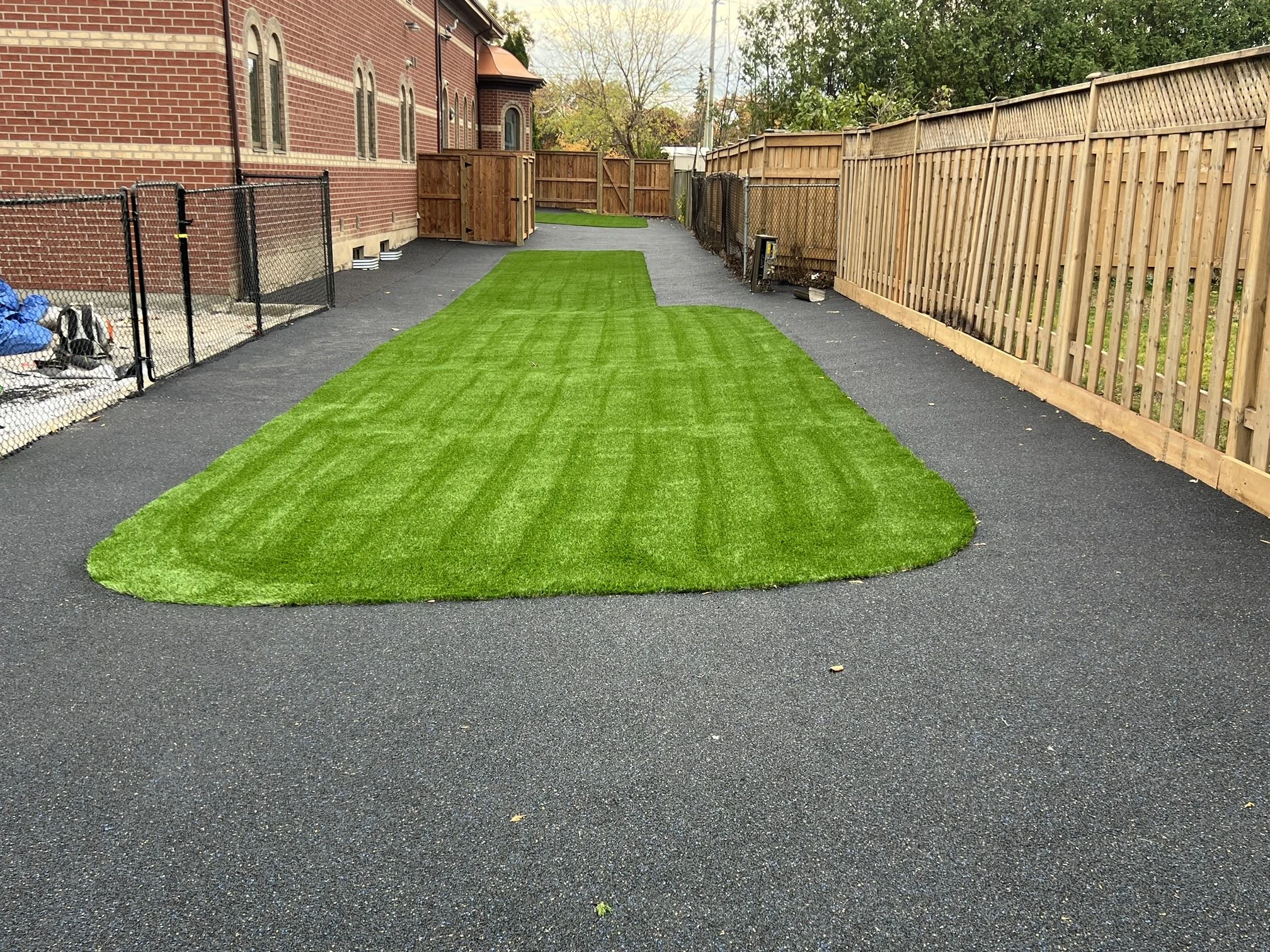 Fresh green turf brightens the playground with a vibrant, inviting surface.