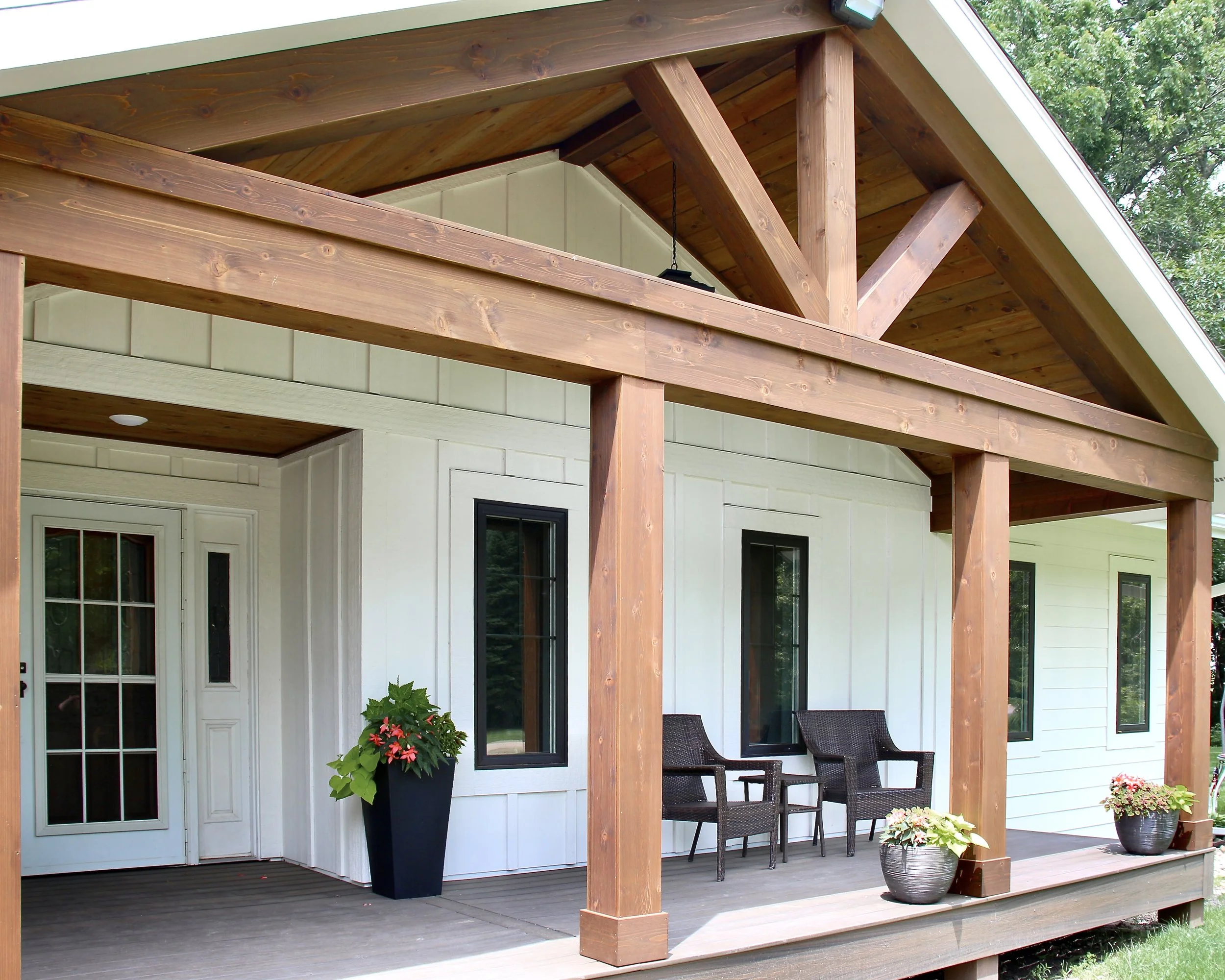 A white house with a covered front porch.