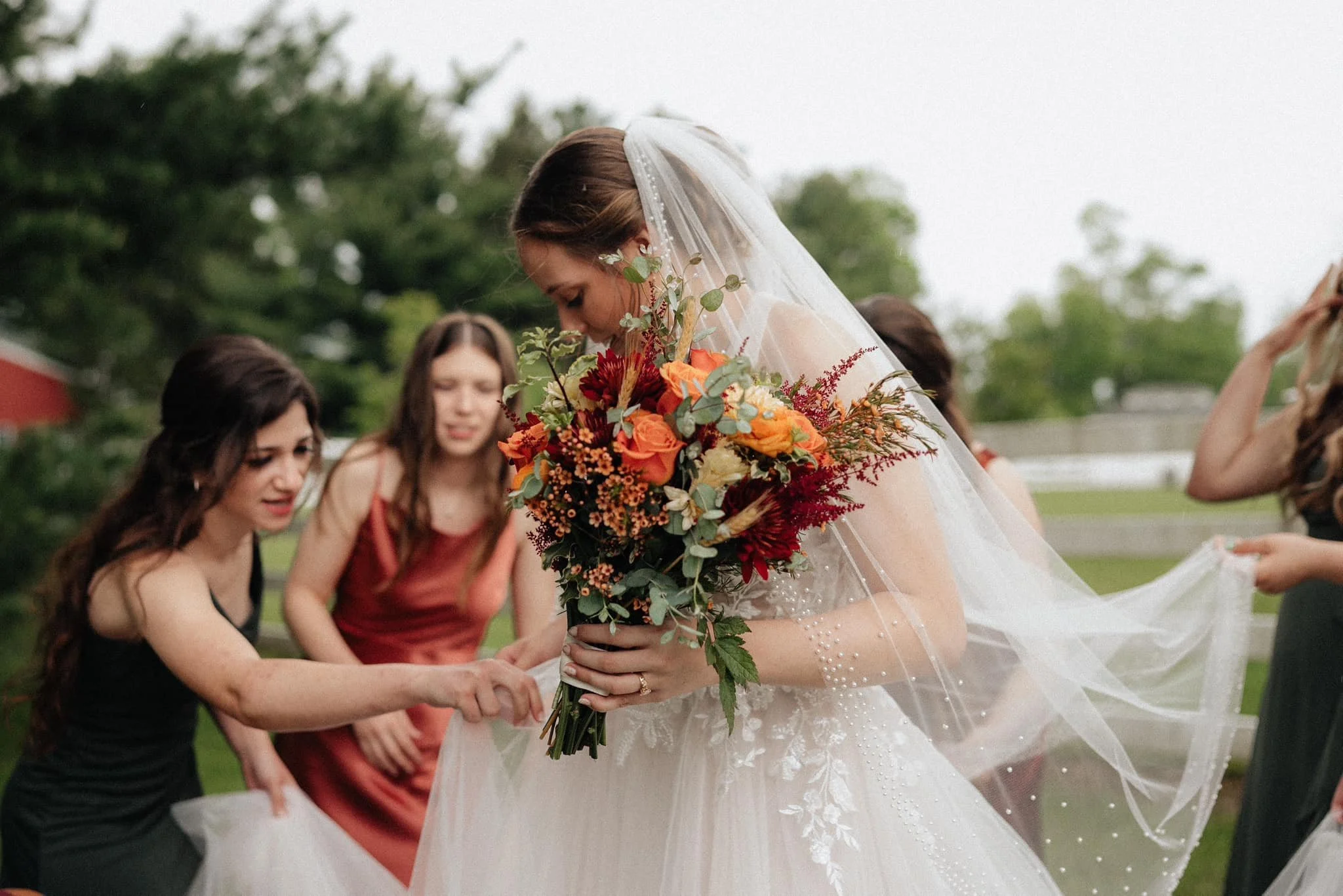 bride-and-bridesmaids-final-touches-outdoors.jpg