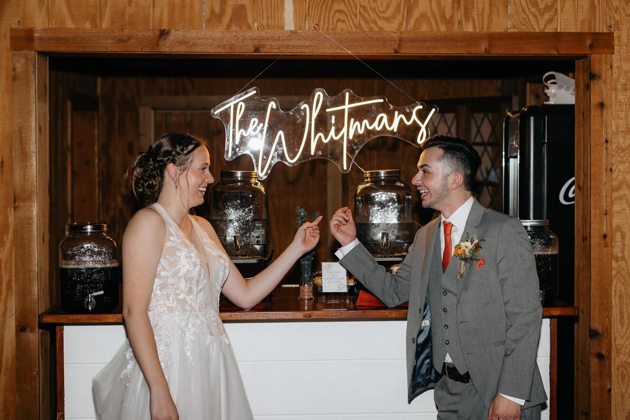 bride-and-groom-laughing-in-front-drink-station.jpg