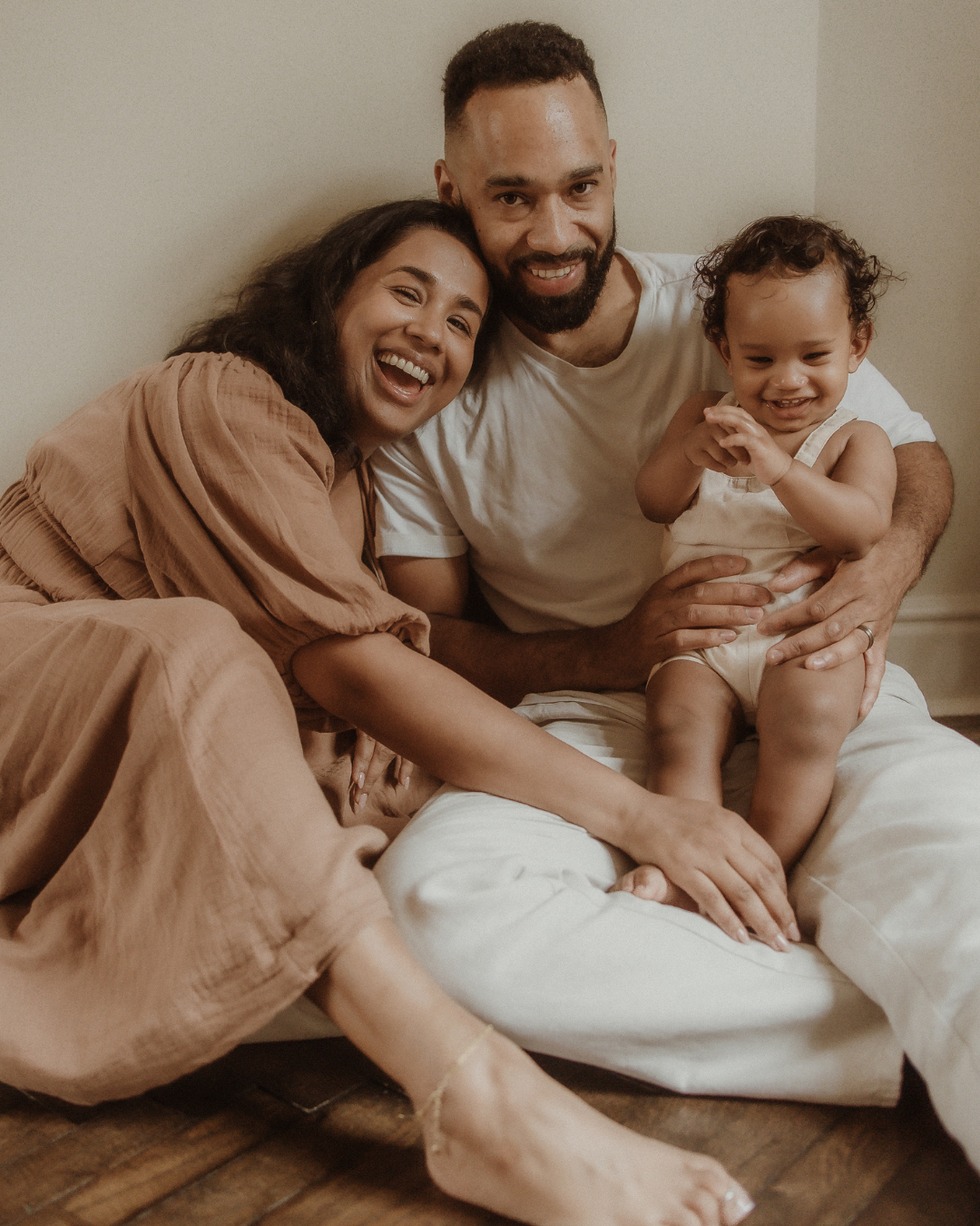 family smiling sitting cuddled together