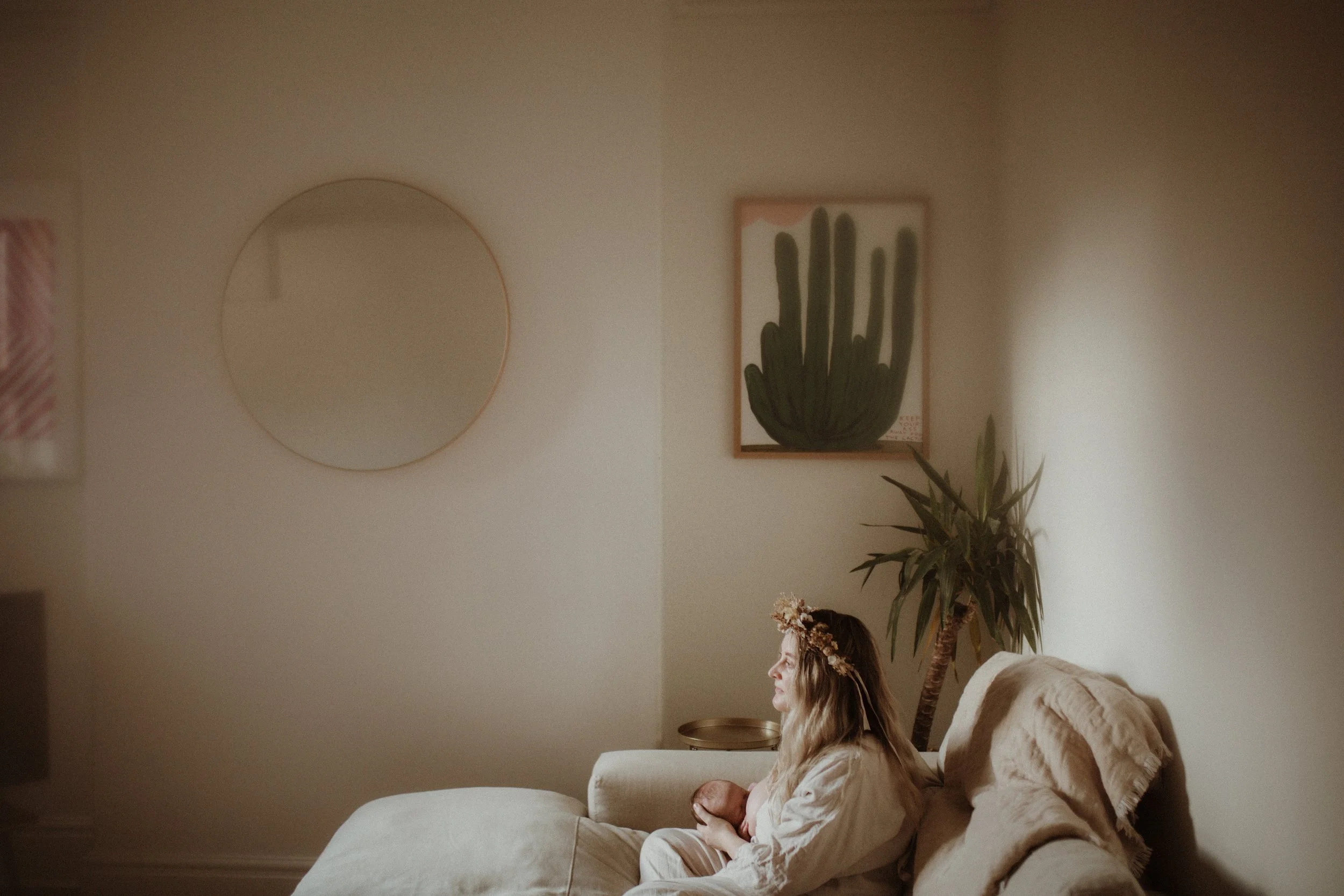 mother breastfeeding baby on the sofa