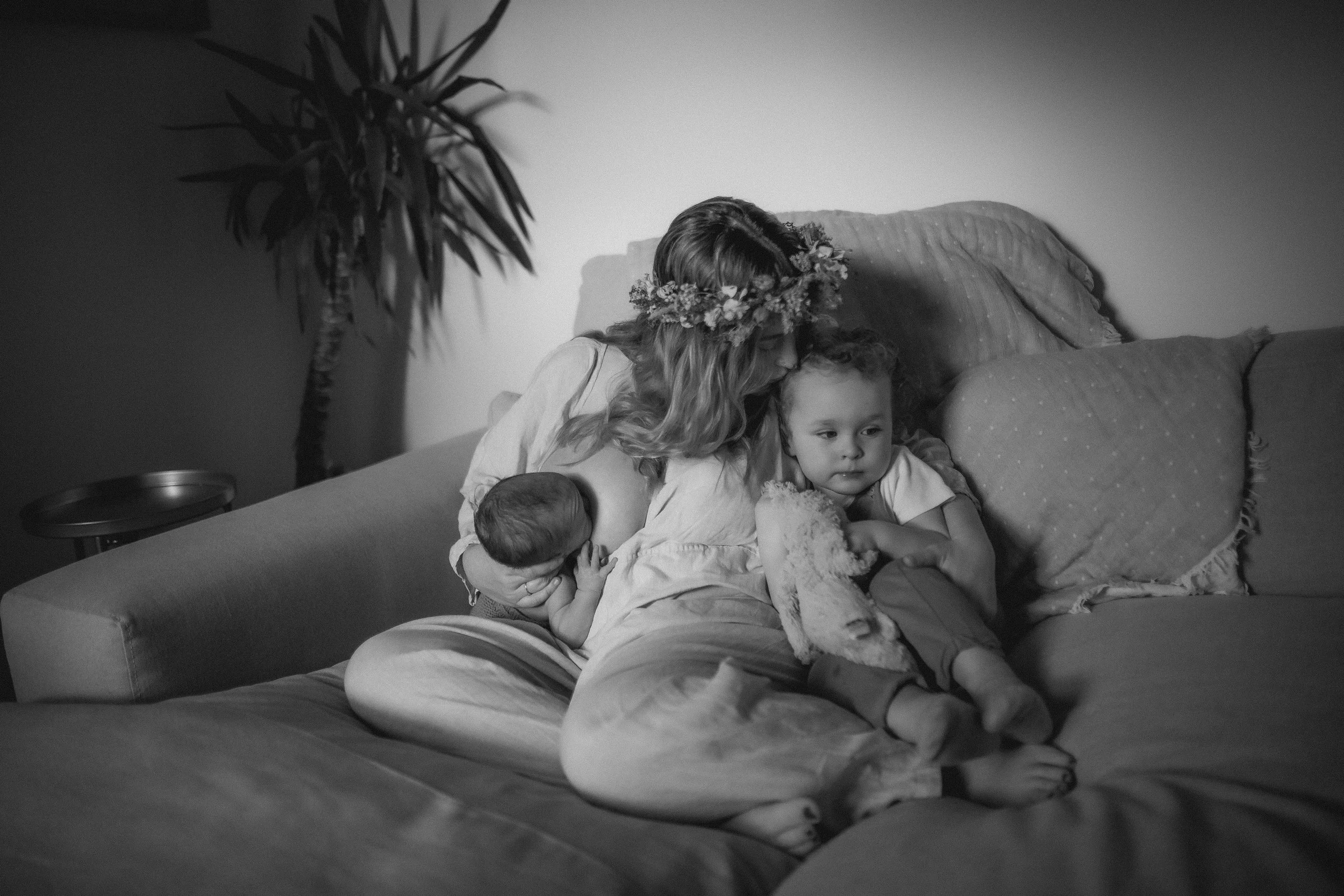 black and white image of mother kissing her child