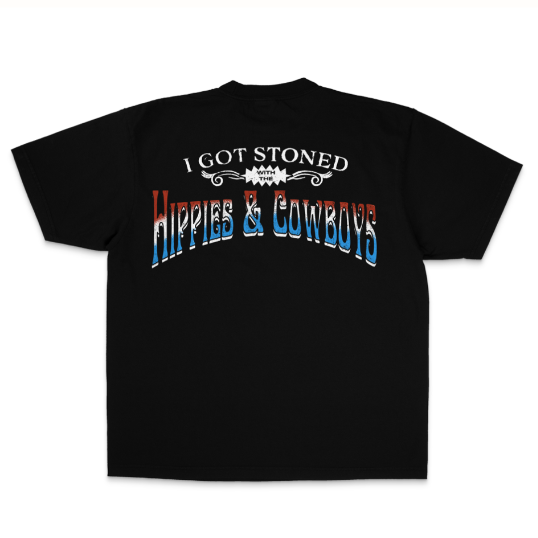 Hippies & Cowboys Got Stoned T-Shirt featuring distressed red, white, and blue Western lettering on the back, bold outlaw country band design, and classic black unisex cotton tee.