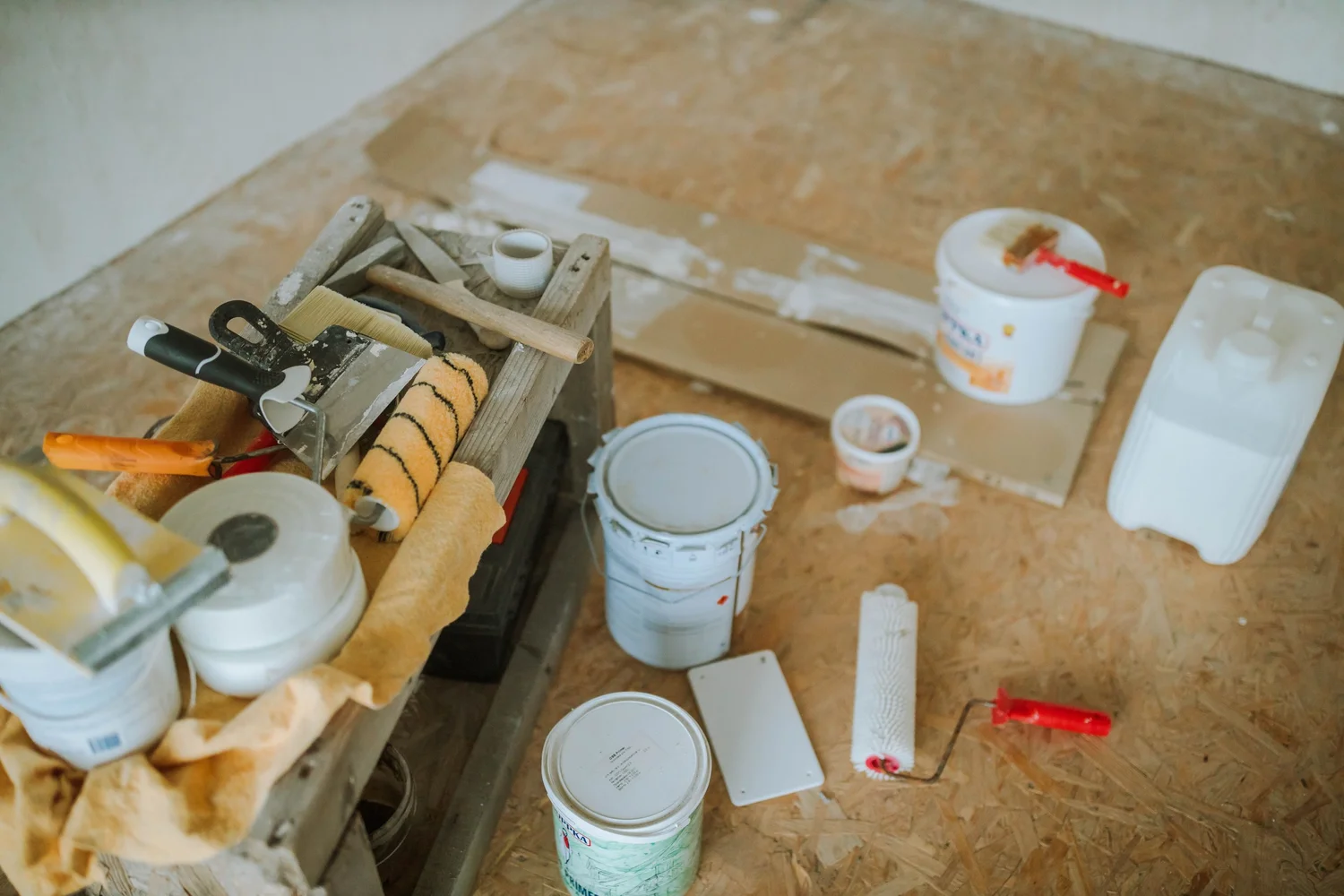 Paint cans, rollers, brushes and other materials gathered for a home renovation project