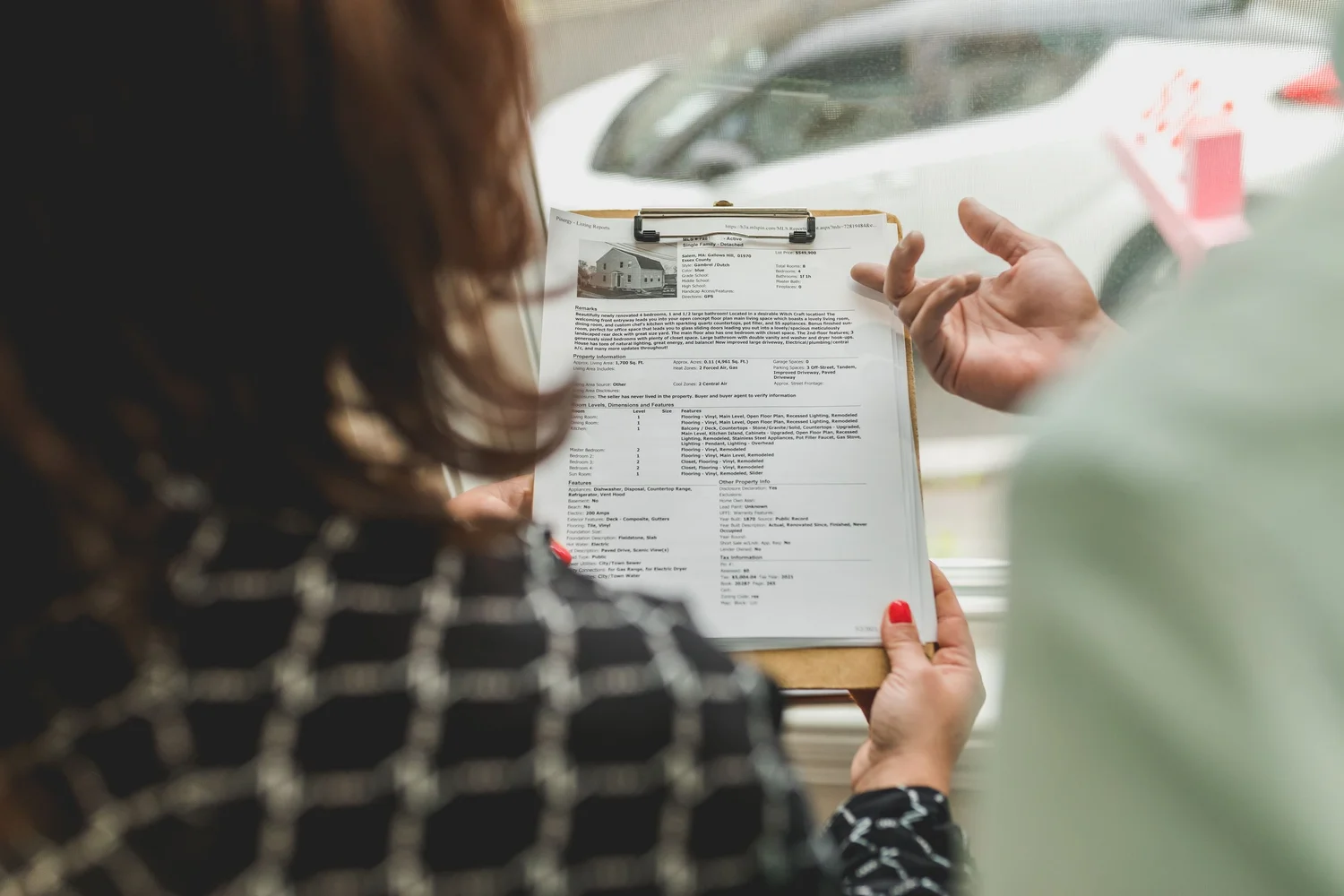 People reviewing property documents on a clipboard