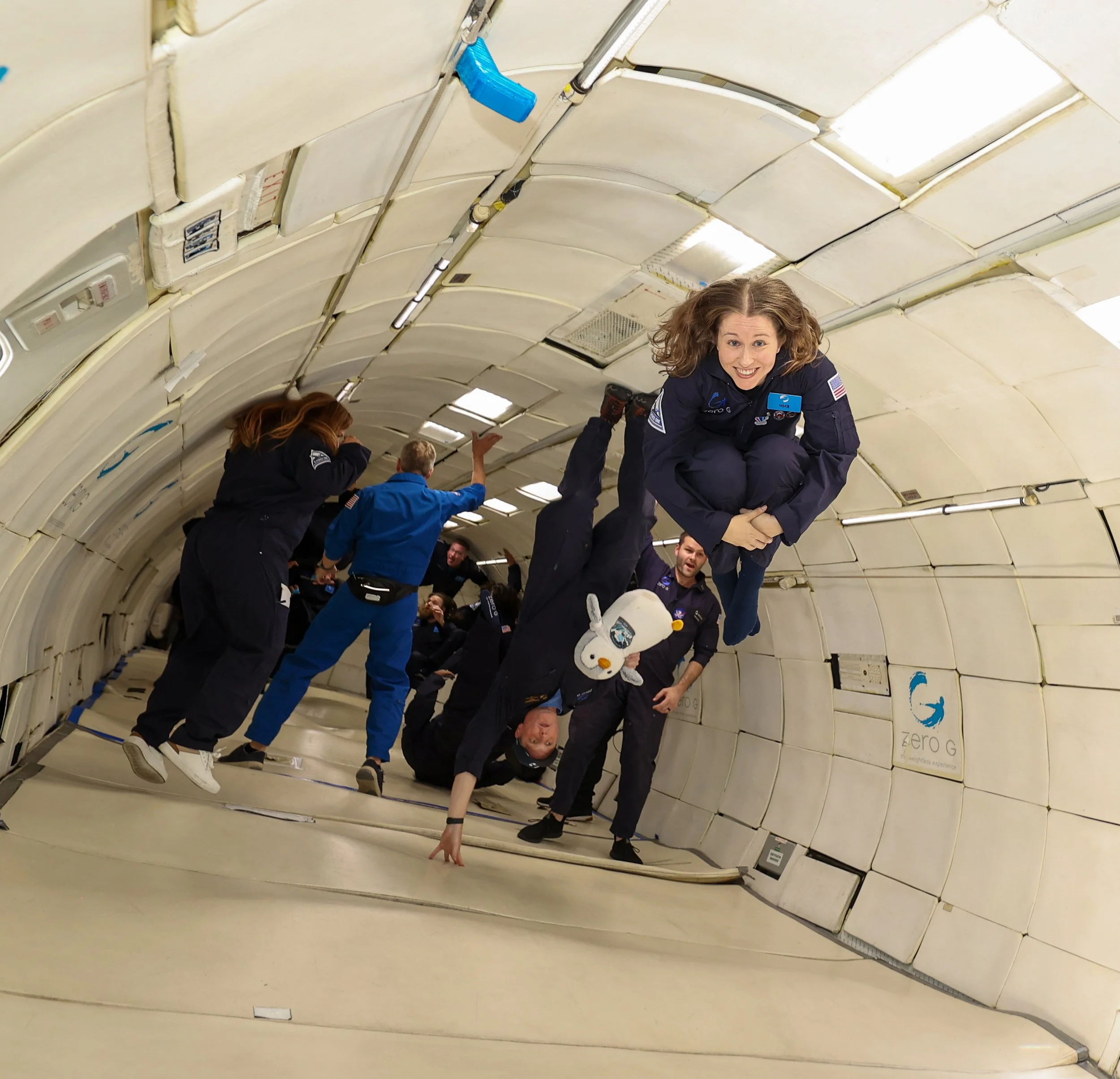 Erin Winick Anthony smiling at the camera while floating during a Zero-G flight, a project for STEAM Power Media