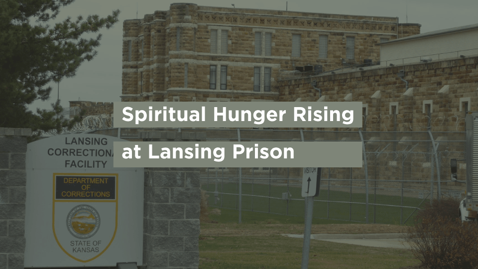 The entrance sign and stone cellhouse buildings of Lansing Correctional Facility in Kansas.