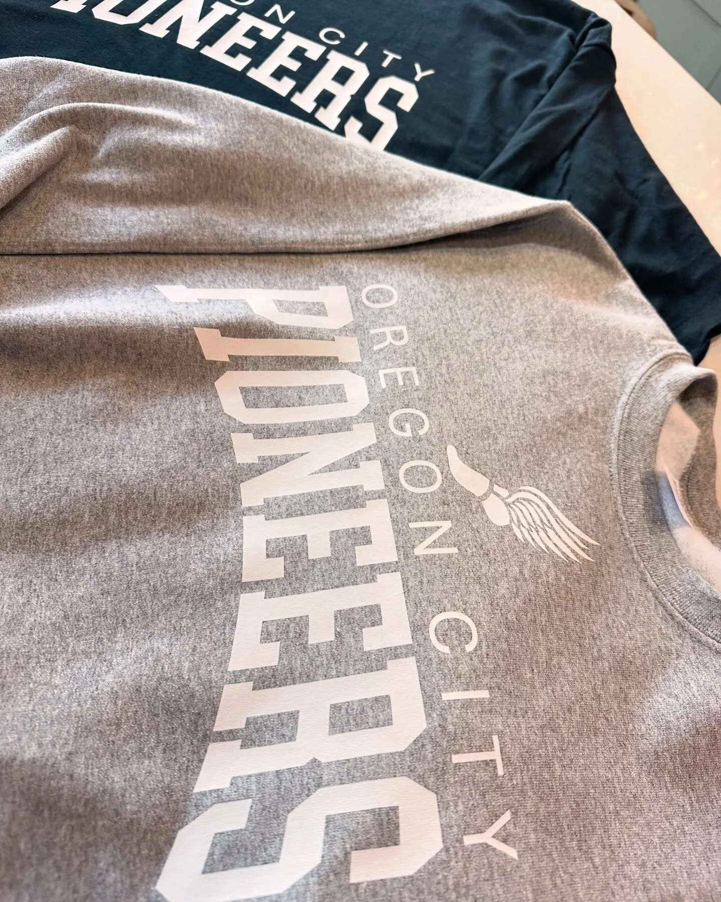 New!!!! OCHS Pioneers Track items! We have an athletic crew sweatshirt as well as a black long sleeve. Perfect for those chilly spring mornings. In stock in our shop at 916 Main Street, Oregon City! Come see us today!!