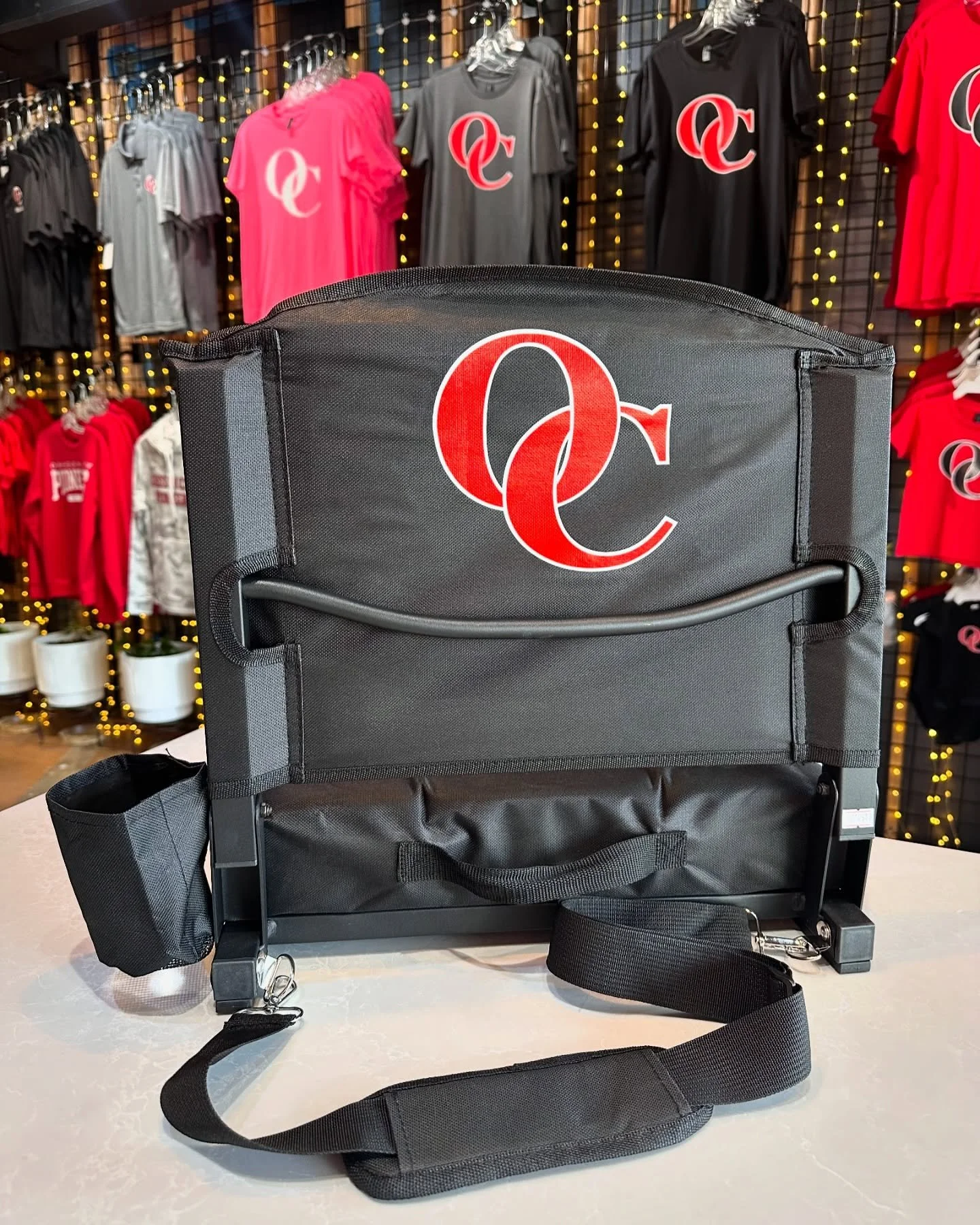 Check out these awesome stadium seats with an OC flair! They have hooks to clamp on the bleacher, allowing you to lean back for more comfort. A thick foam seat keeps you comfortable longer. There is also a cup holder and handy strap for easy travel.
