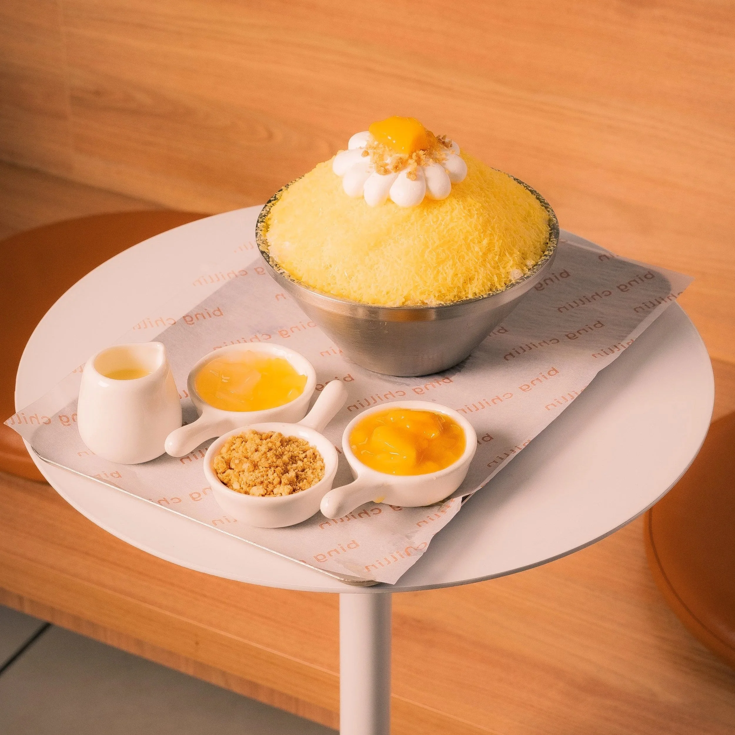 Mango bingsu — mango shaved ice with condensed milk, mango cubes, oat crumbs and coconut jelly