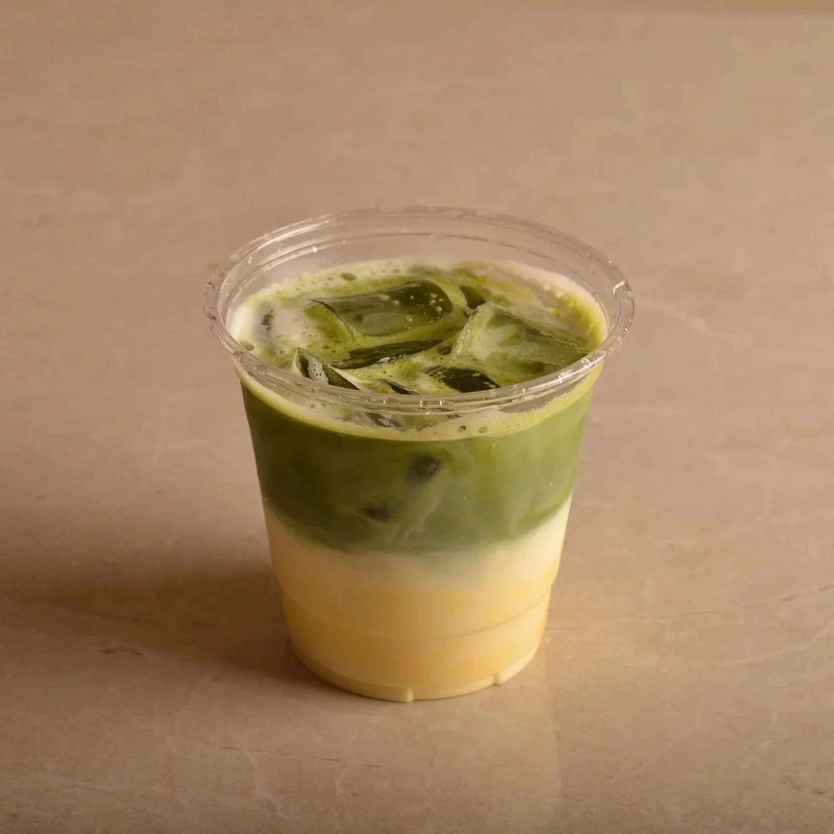 Iced mango matcha with mango cream, milk and ice