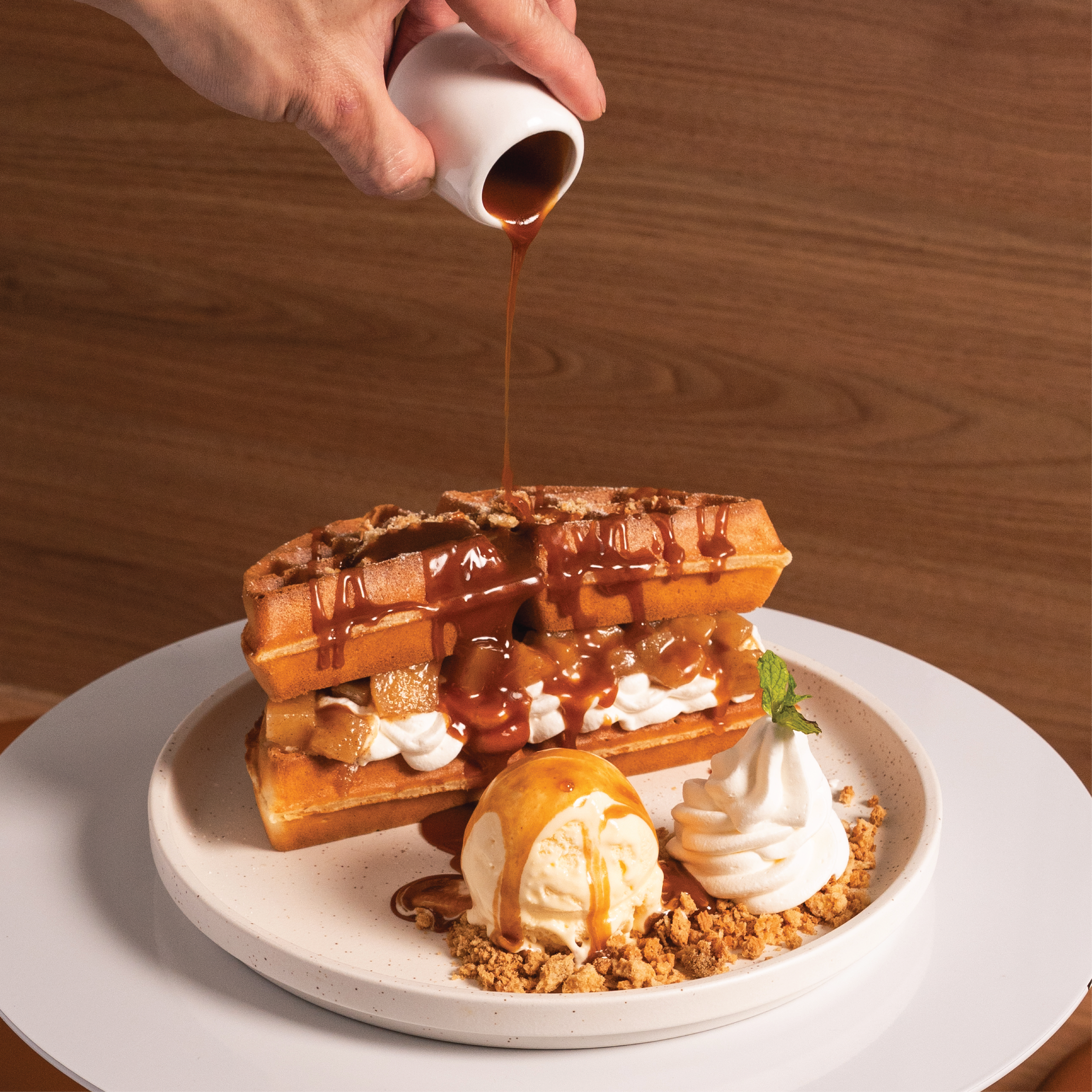 Apple Pie waffle with caramelised apples, oat crumble, caramel sauce and vanilla ice cream
