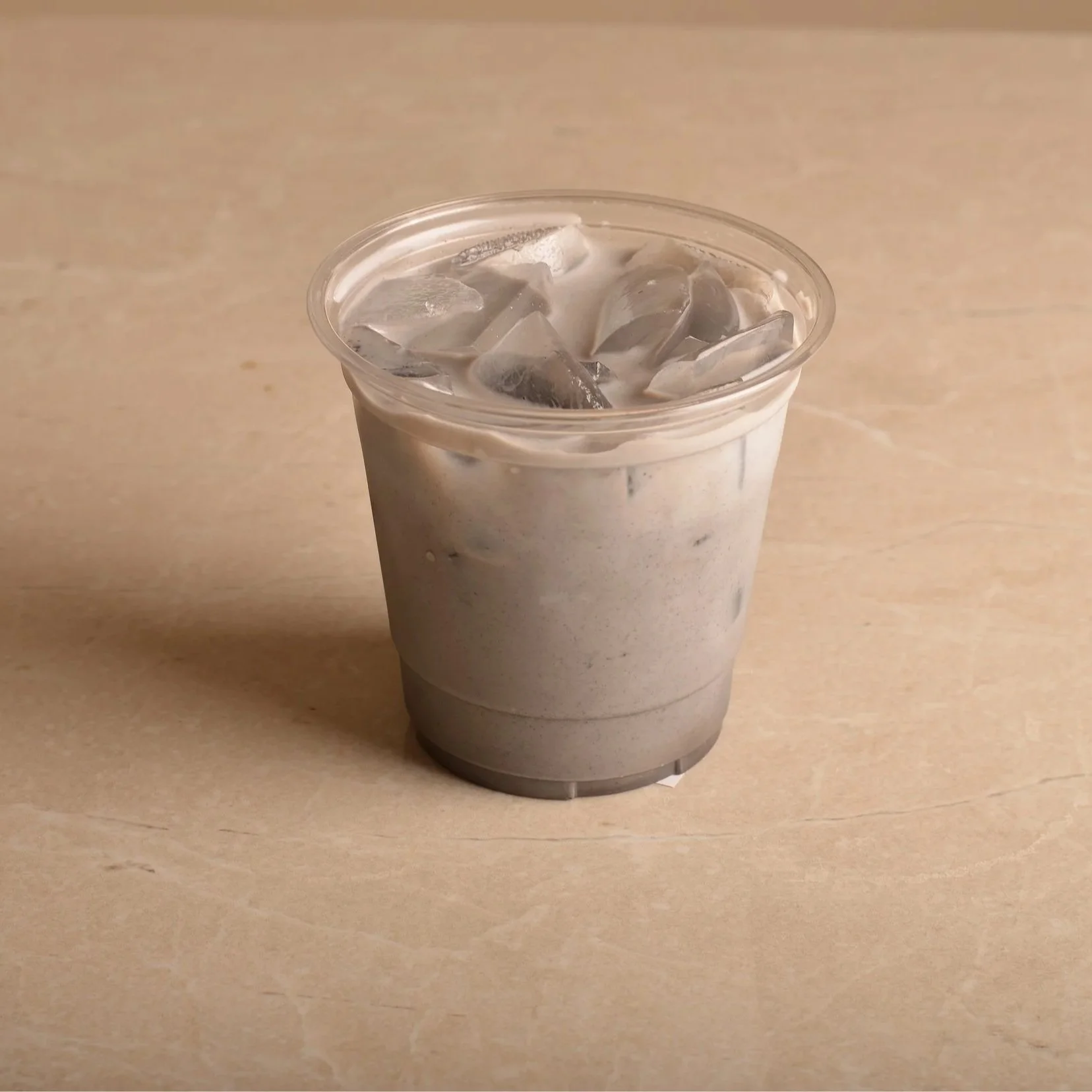 Iced black sesame with milk and mango cream over ice