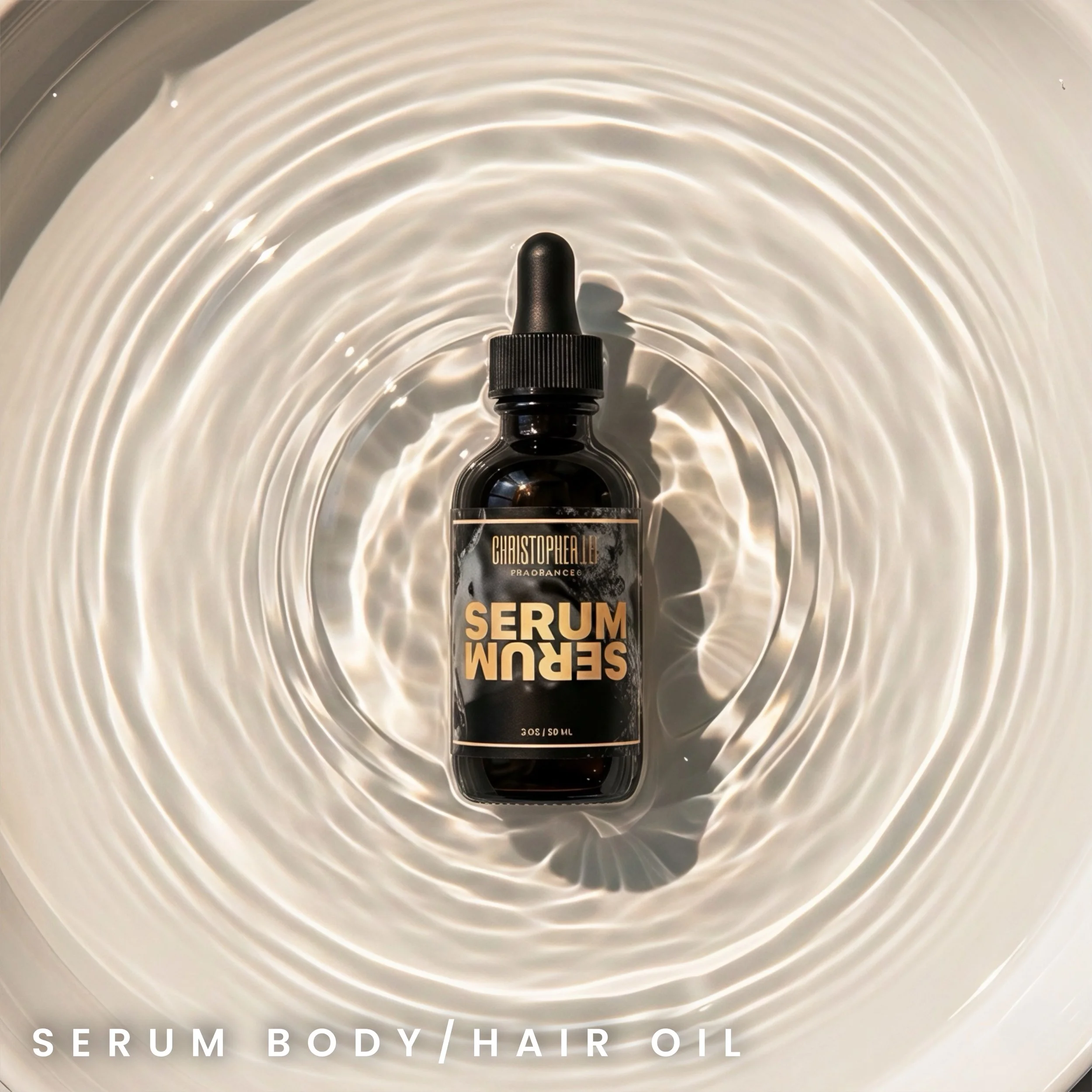 A small black bottle of serum body and hair oil with a dropper cap, labeled 'Serum' in bold beige letters, floats in a reflective surface creating circular ripples.