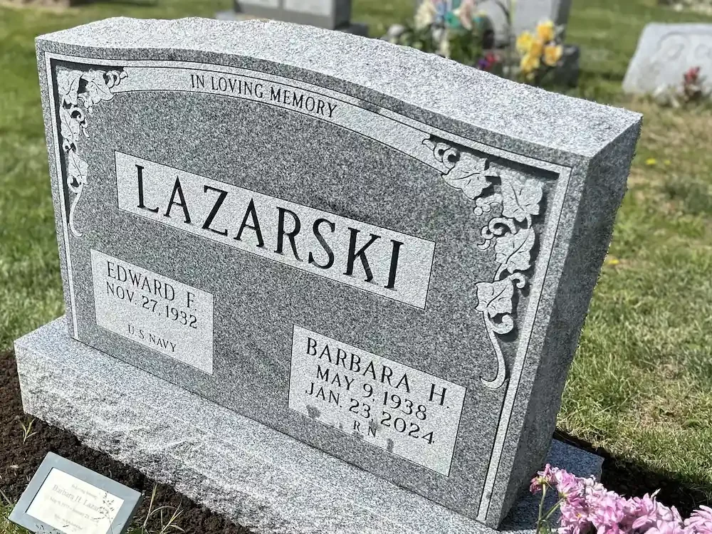 side angle of headstone showing the rocky texture on the top and sides