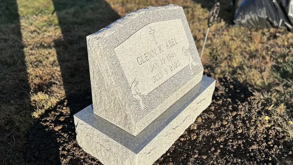 Slant memorial with base and cursive writing