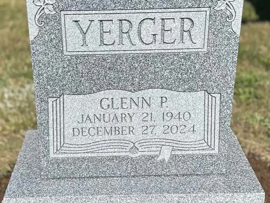 headstone with a panel shaped like a book