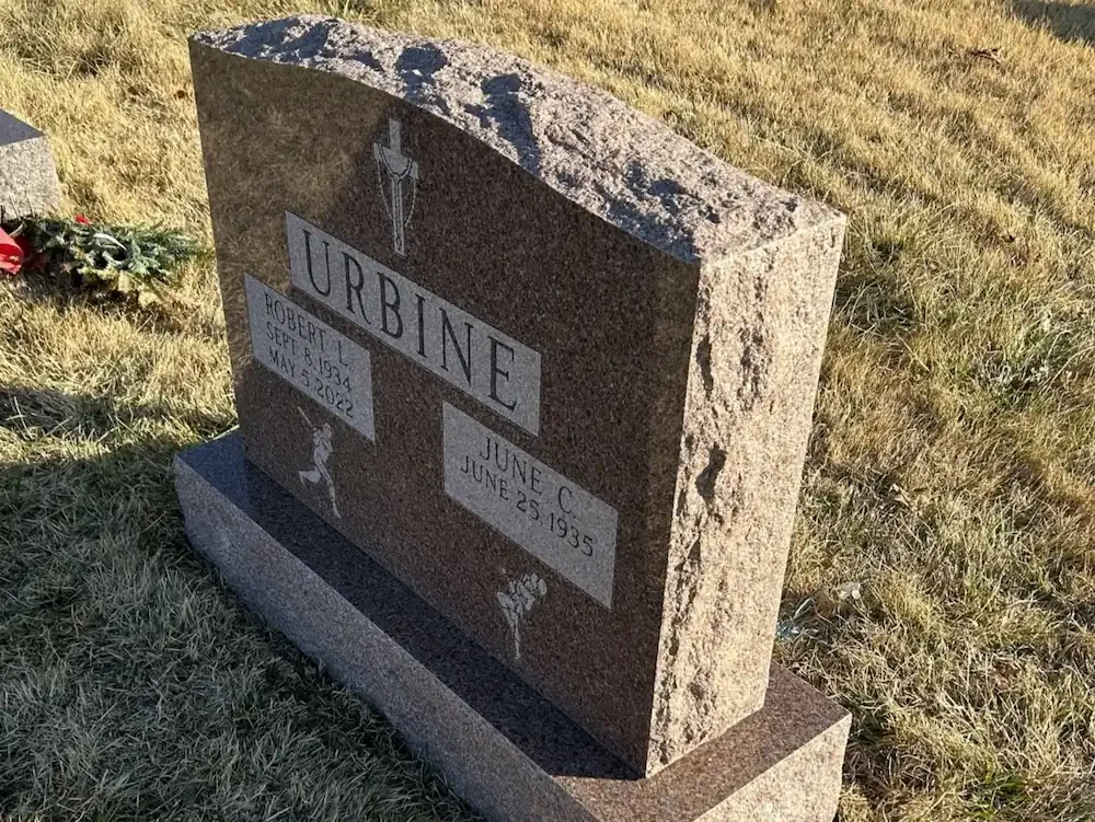 side angle of headstone with rocky looking top and side