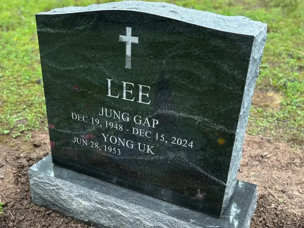 side angle of headstone with rock pitch side