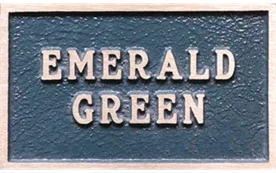 bronze plaque painted a light blue-green color
