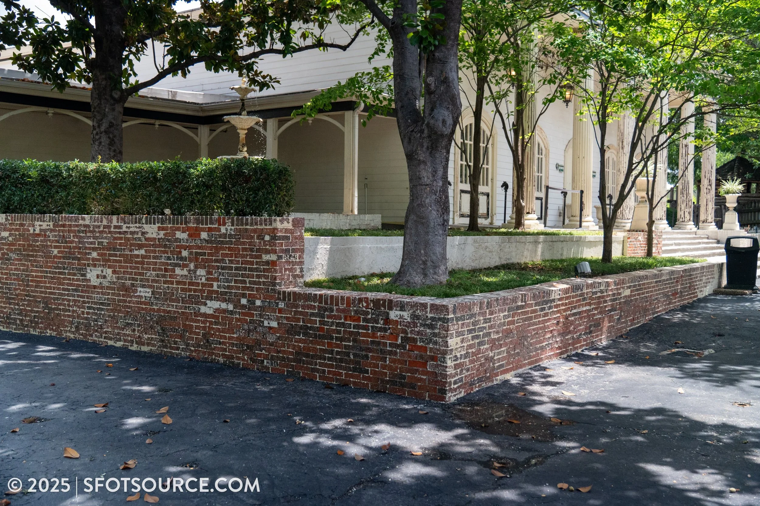 Exterior brick flower beds has been stripped of paint.