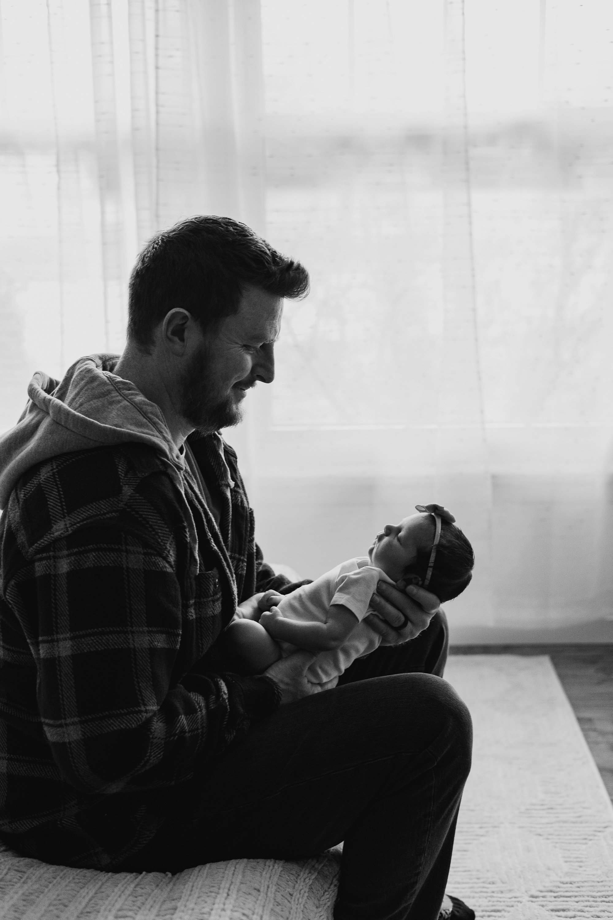 A profile photo of dad holding his newborn daughter.