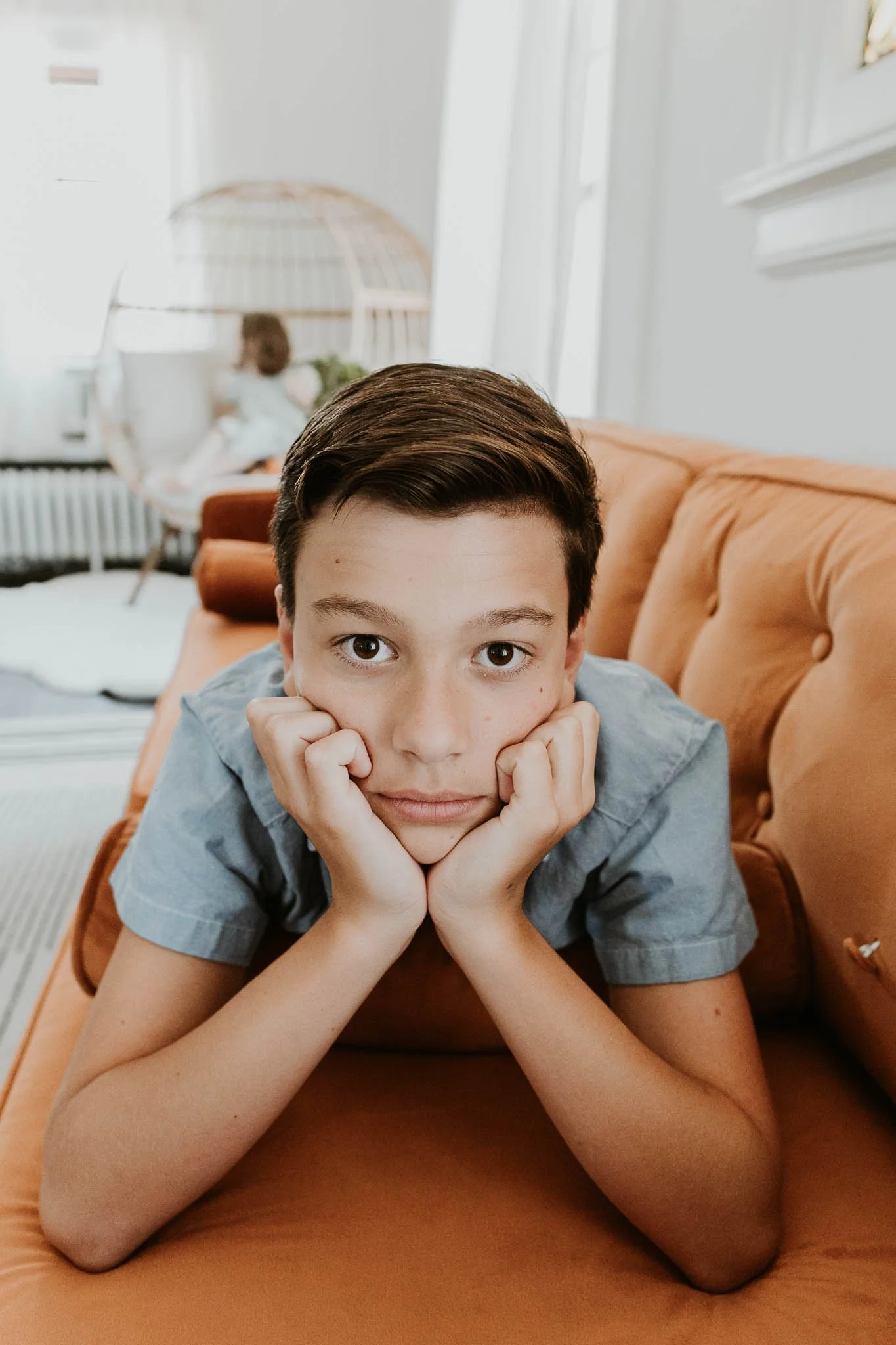 A tween looks directly into the camera for his headshot during a family photoshoot in Bloomington, Illinois.