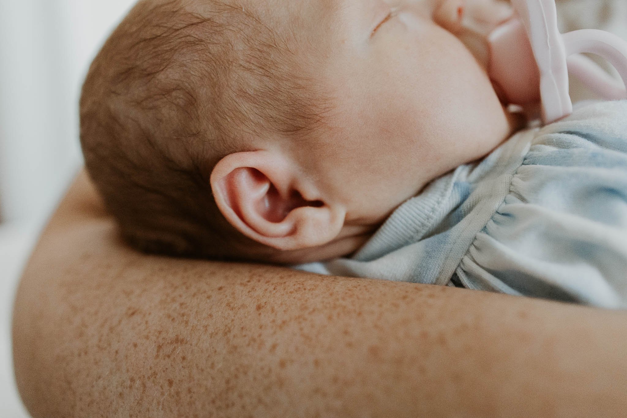 Details captured during a newborn photography session - ears, hairline, profile, and their favorite soother.
