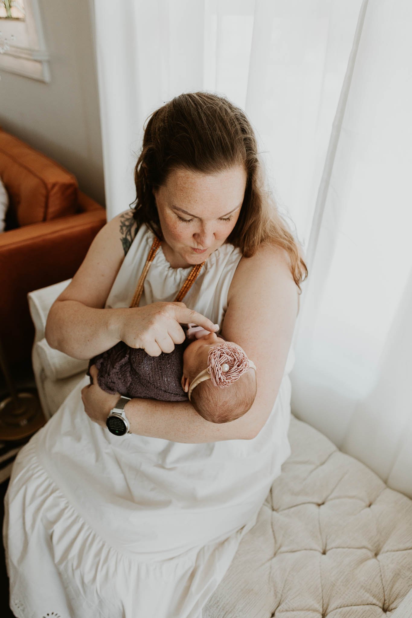 A mother boops her daughter's nose during their photoshoot with newborn photographer Liz Walsh of Bloomington, Illinois.
