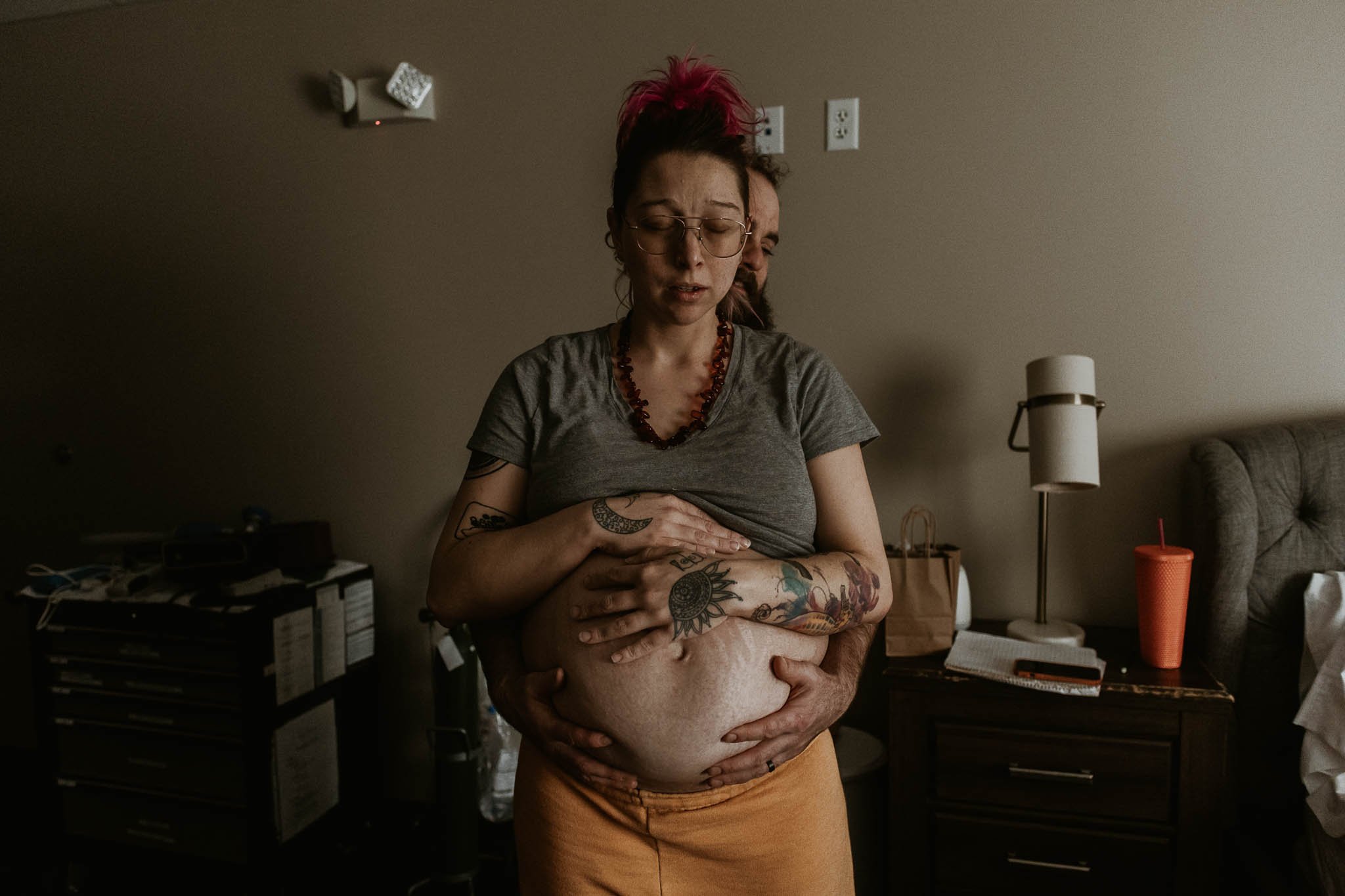Liz Walsh of Liz Walsh Doula & Photography captures early active labor between a couple as they work together in the lift and tuck move.
