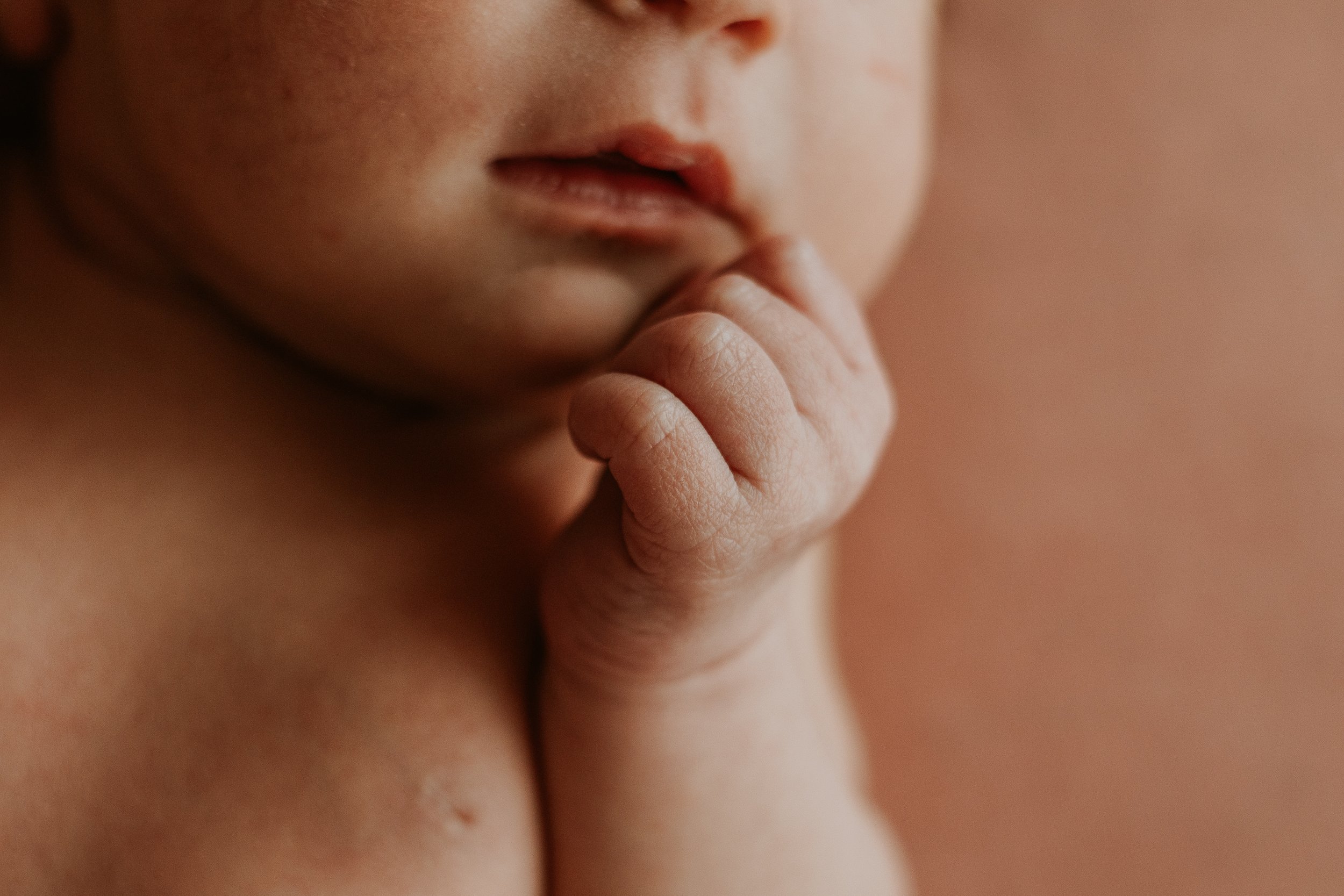 Tiny lips and fist are captured during this newborn photoshoot in Bloomington Illinois.