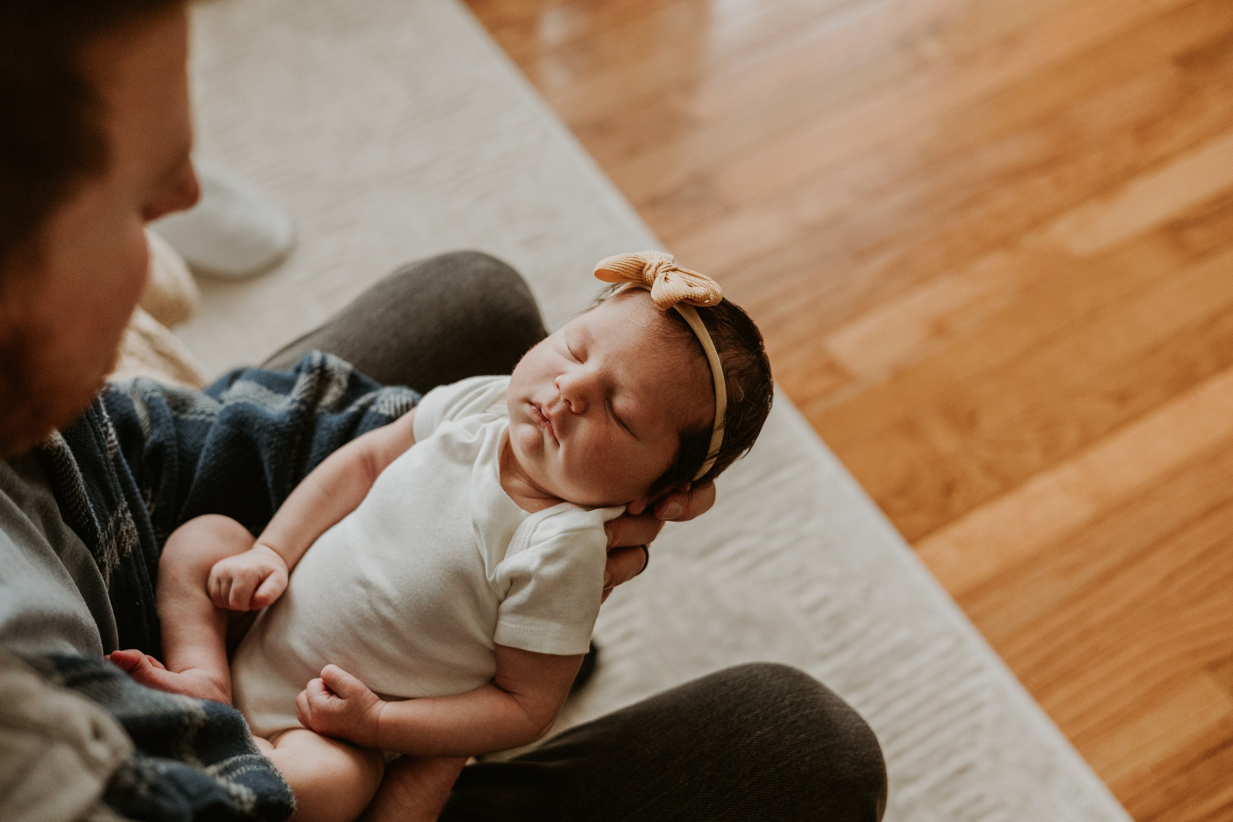 A peaceful snooze in dad's arms during her newborn photoshoot in Bloomington Illinois.