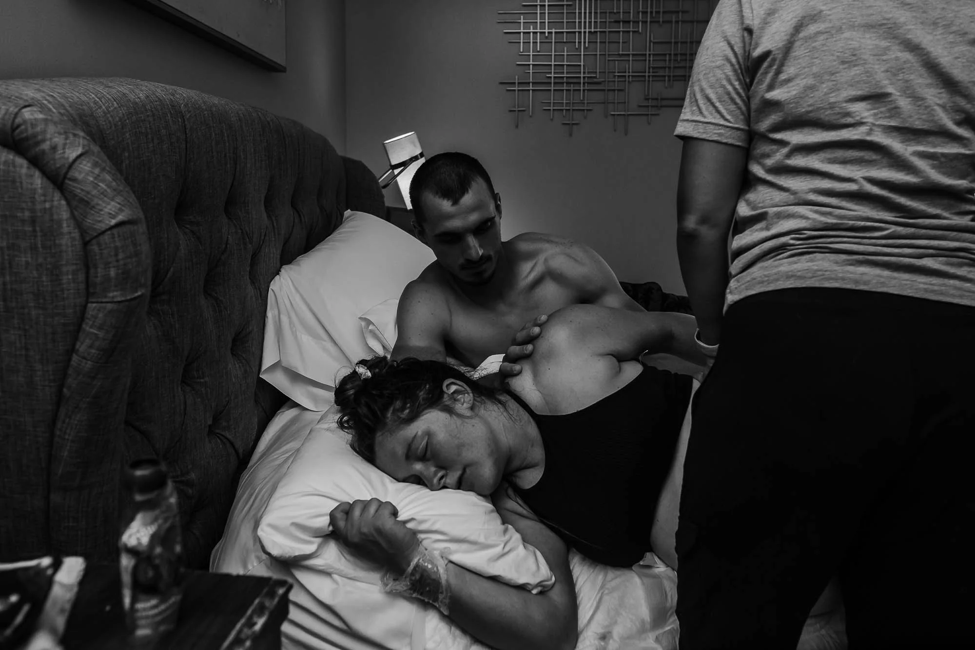 A husband comforts his wife while she's in labor.