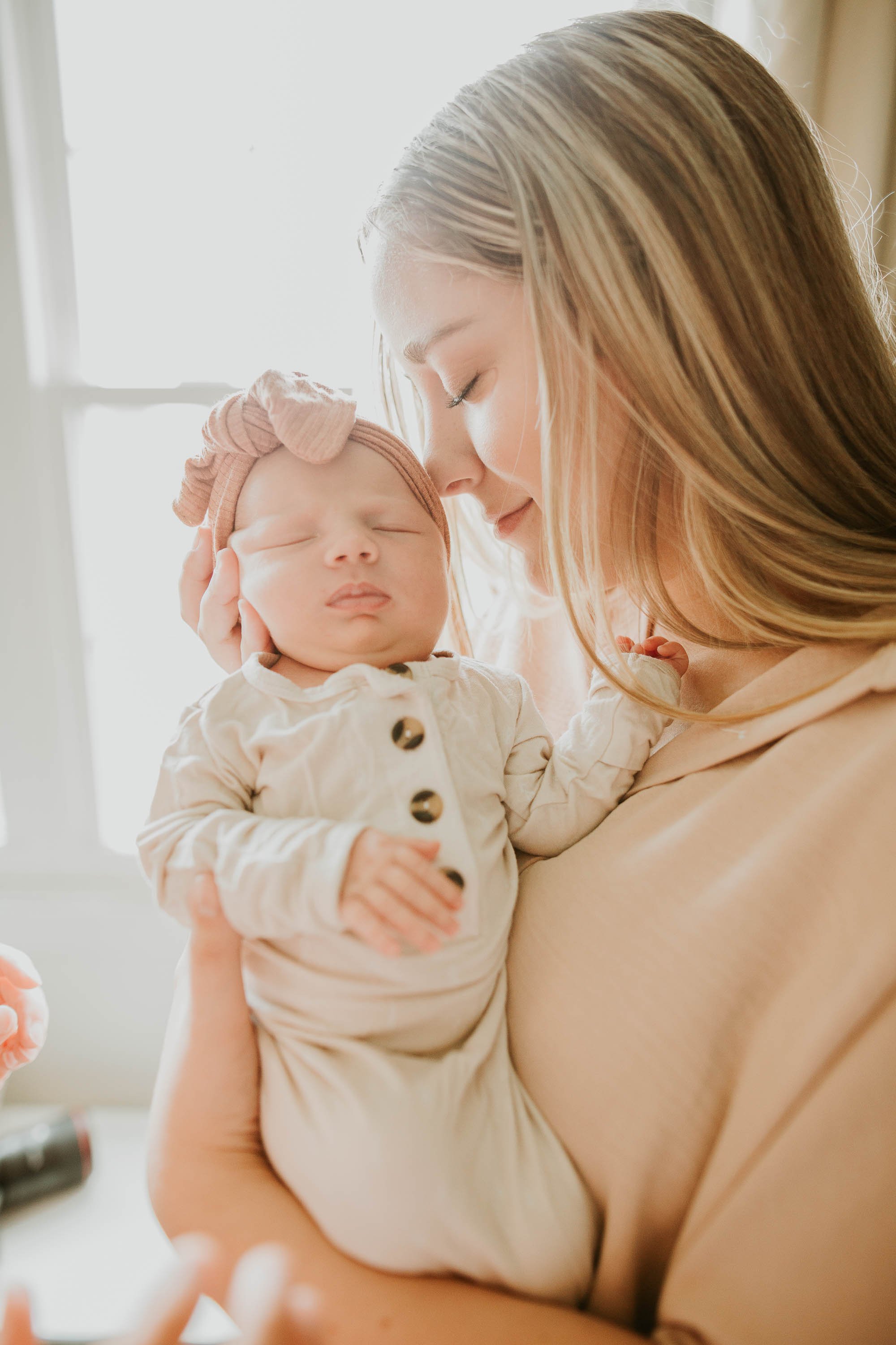 Bright and airy newborn photos near windows are a favorite to capture.