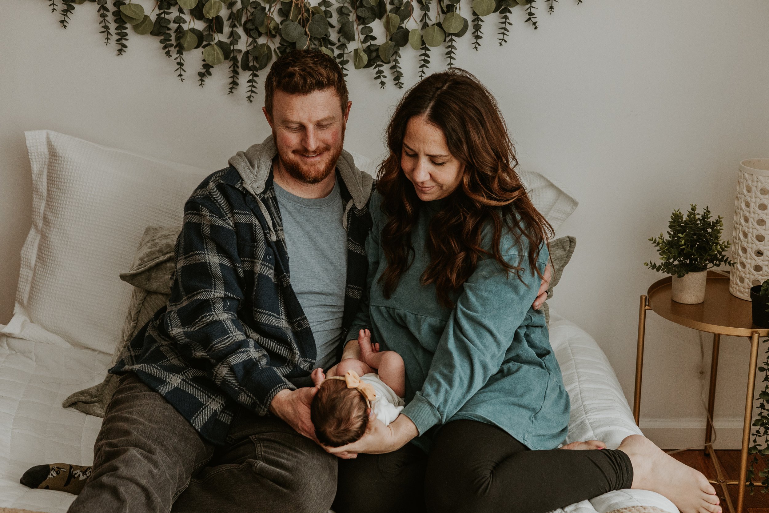 Mom and dad gaze lovingly at their new daughter's face.