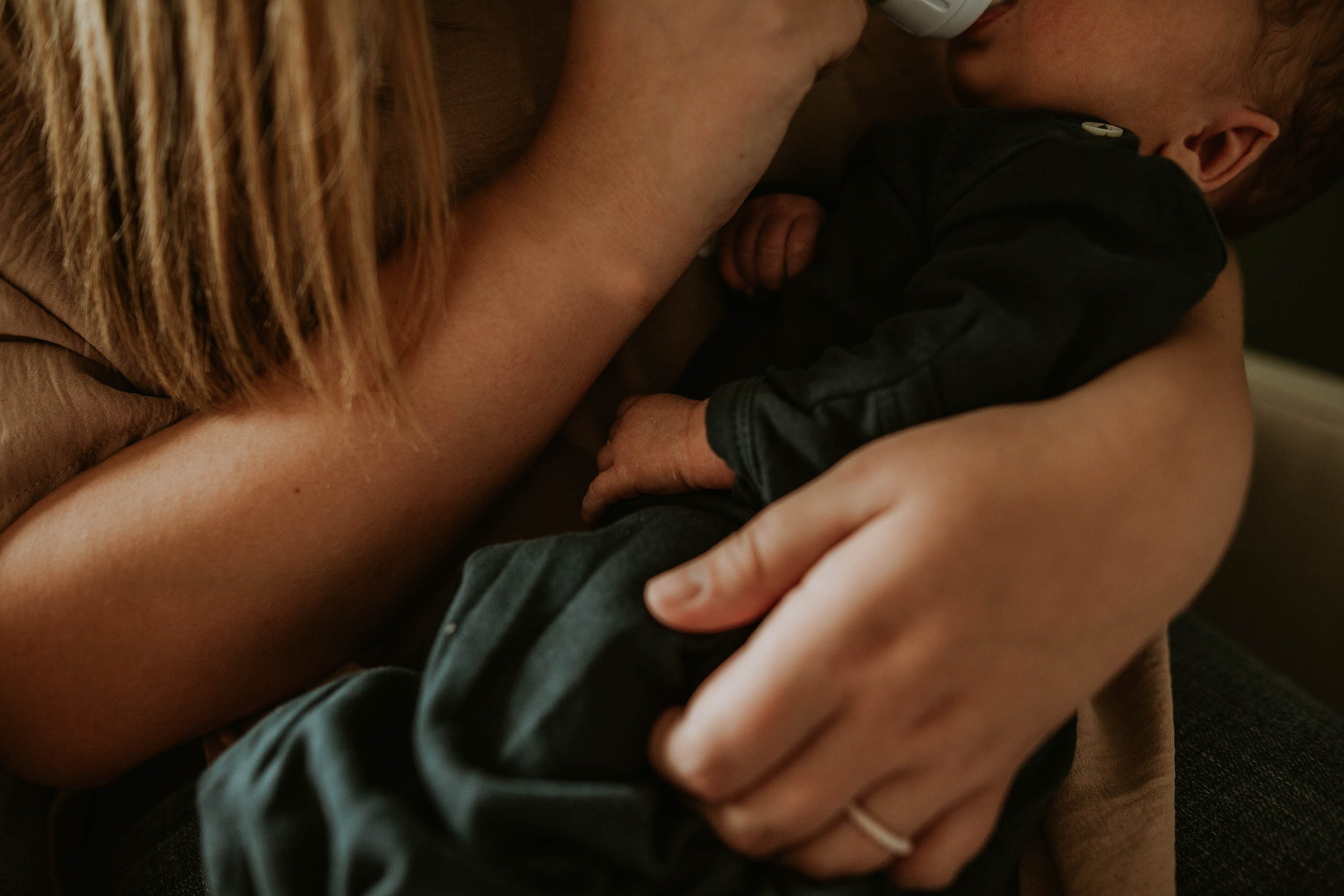 No detail is too small, including mom's hands supporting her baby through a feed.