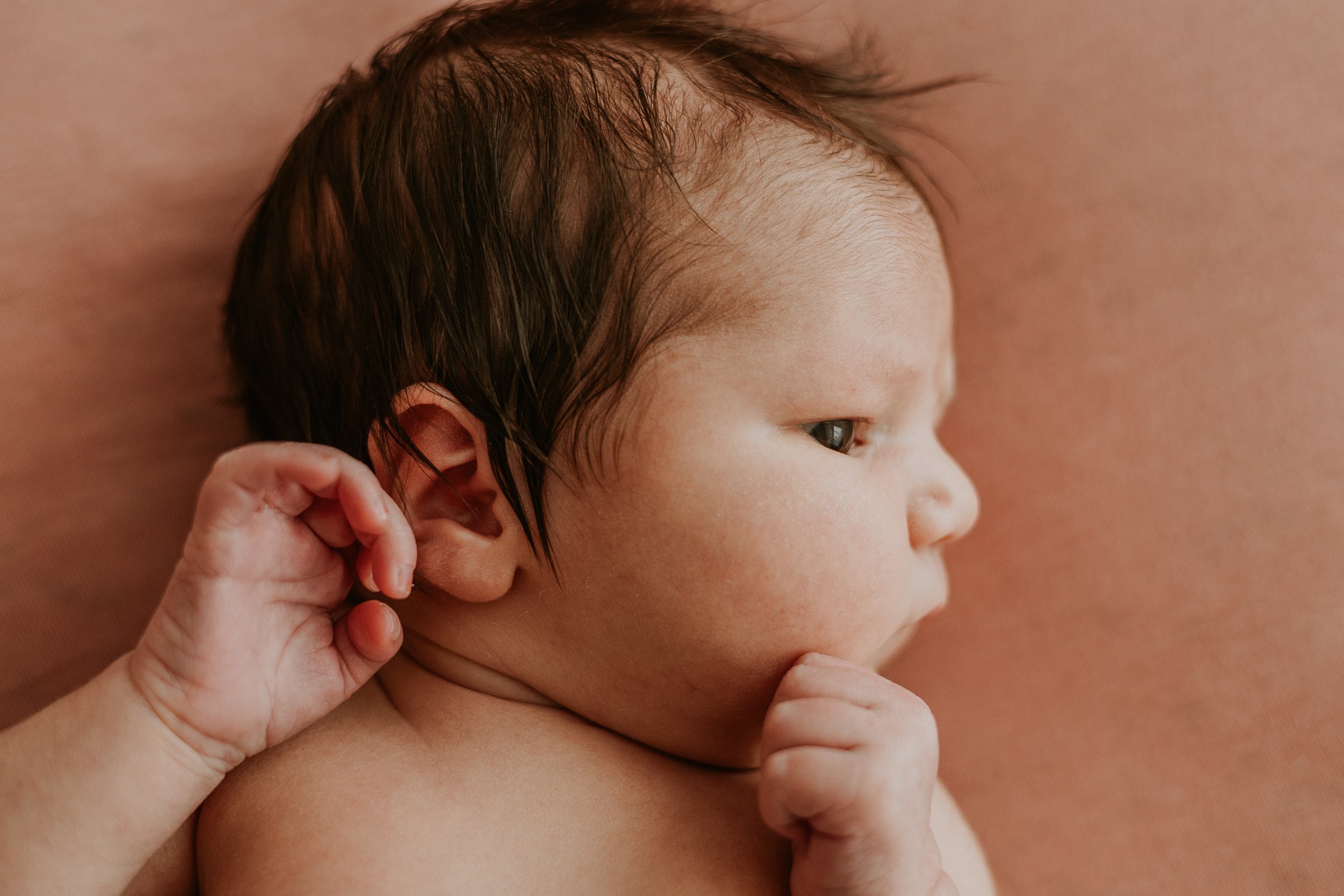 Profile pictures of newborns show their delicate features, from forehead to nose, down to her lips and chin.