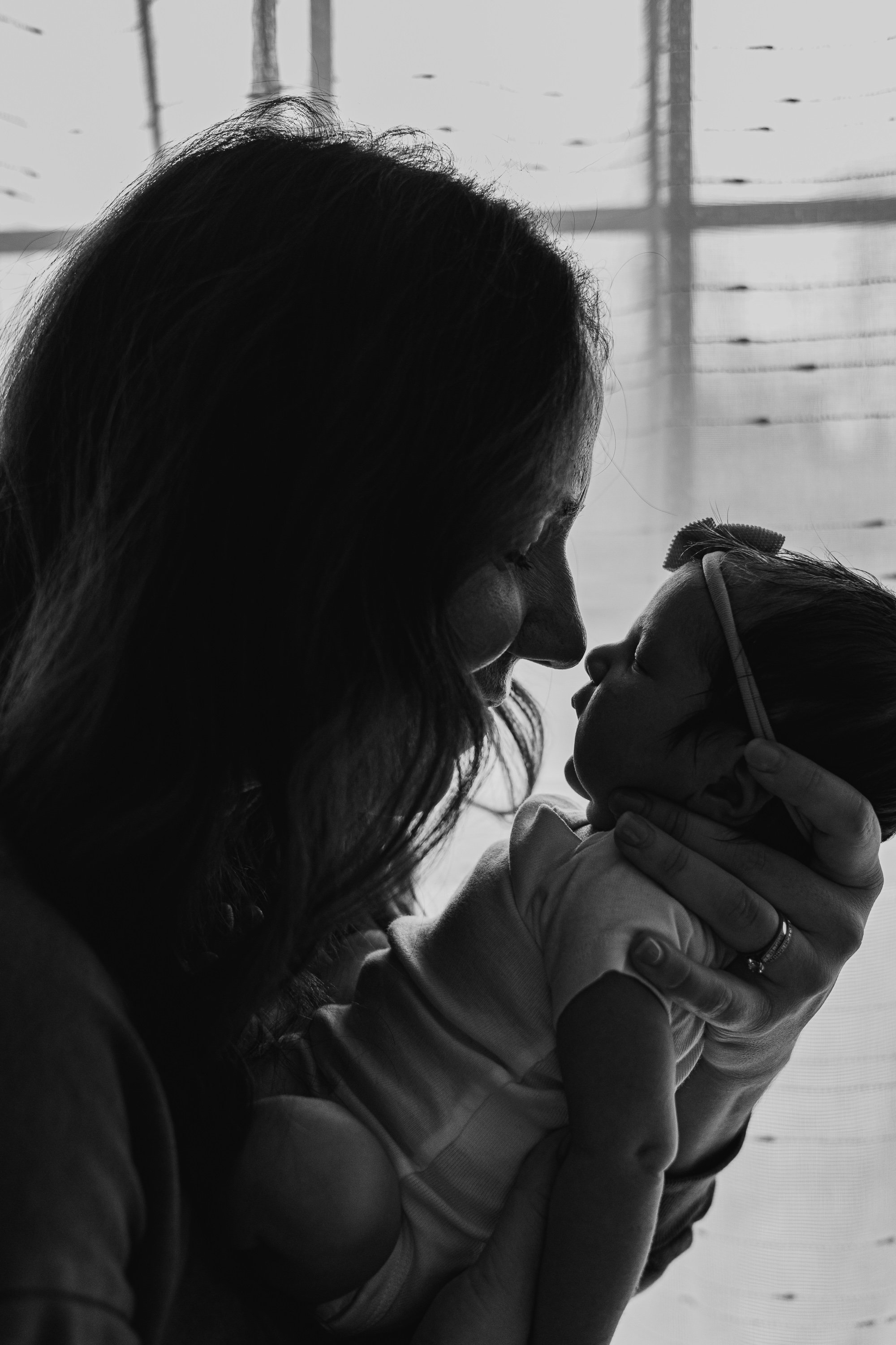 Mom and baby are nose to nose during their newborn photoshoot in Bloomington Illinois.