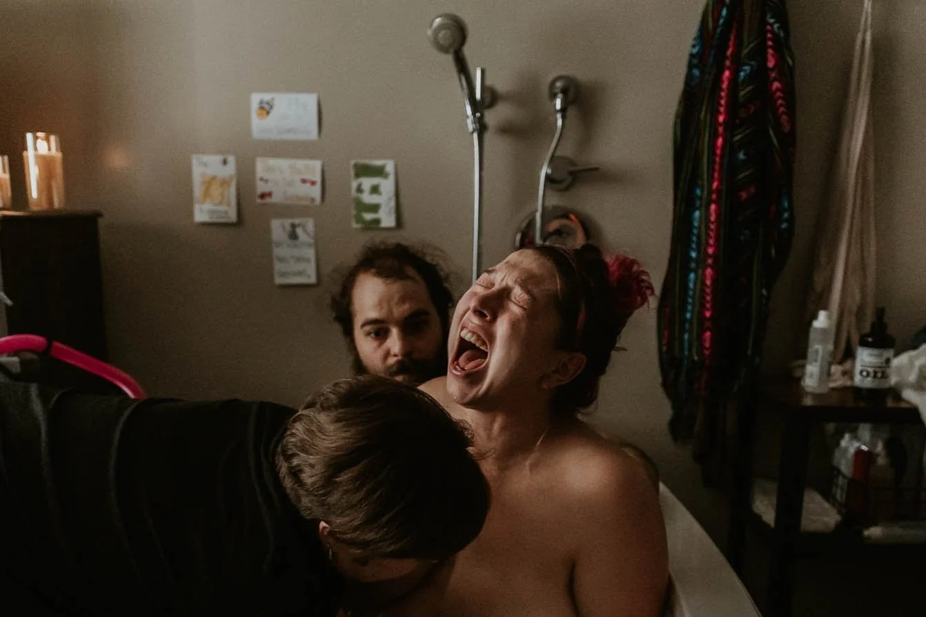 A woman in labor roars her baby out after a long, arduous labor a birth center in Bloomington, Illinois.