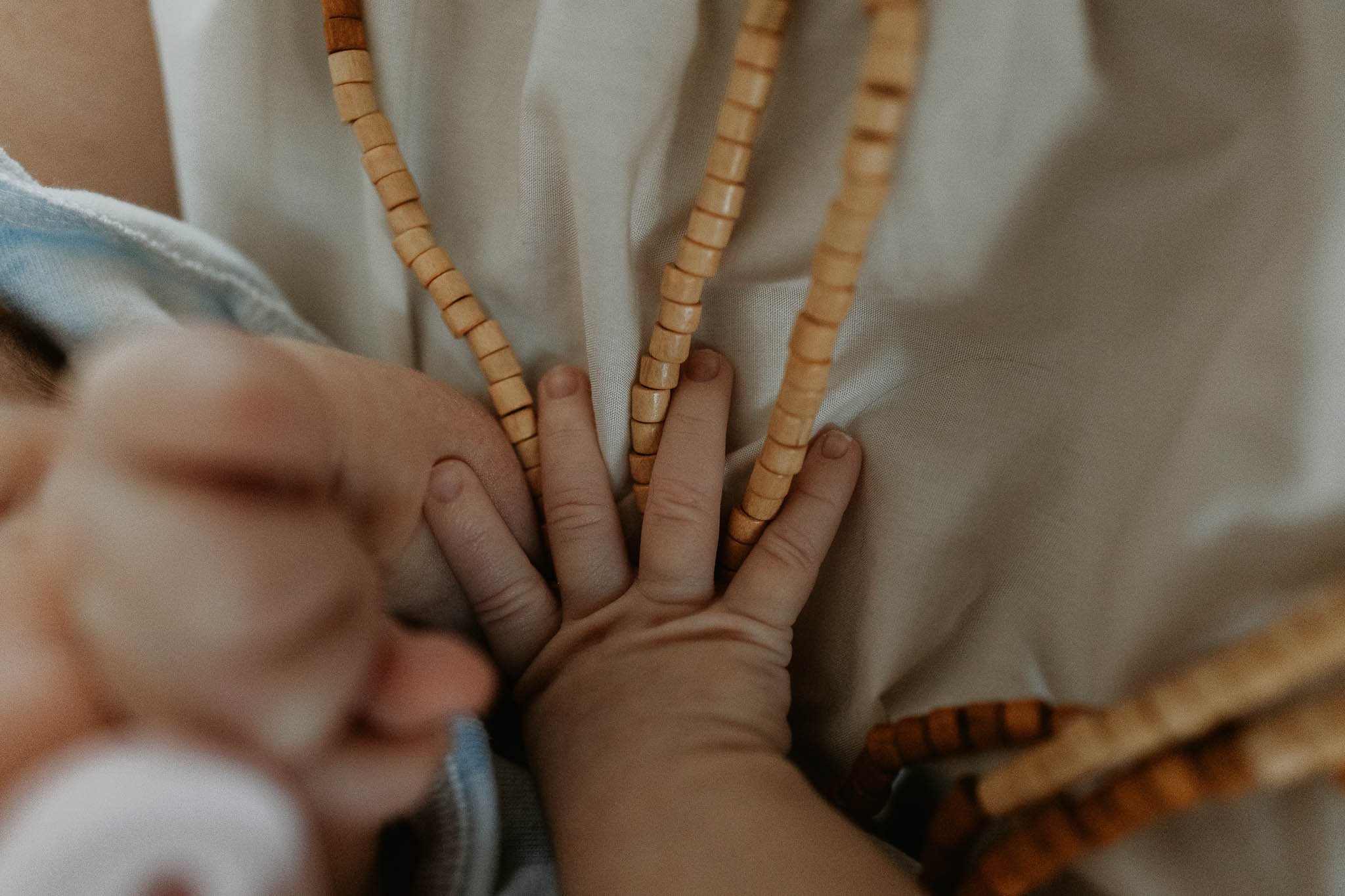 Baby's love a warm heartbeat, like this newborn, snuggle next to her mama as she sleepily puts her hand on mom's heart.