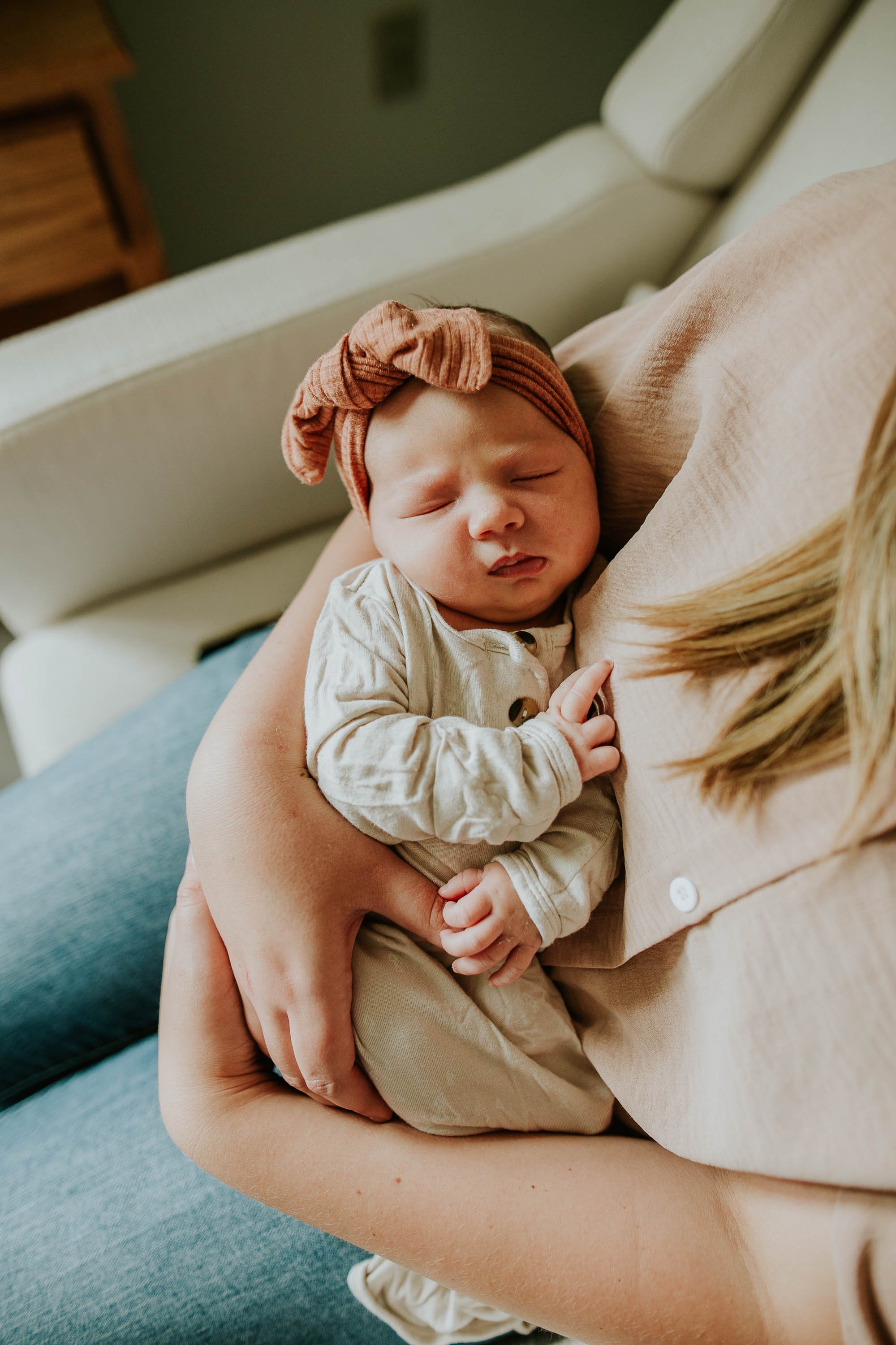 Sweet baby snuggles in mama's arms.