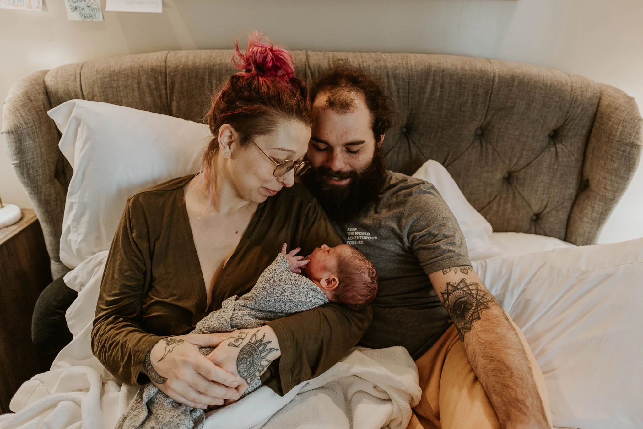 A couple smiles down at their newborn baby after giving birth at a birth center in Bloomington, Illinois.