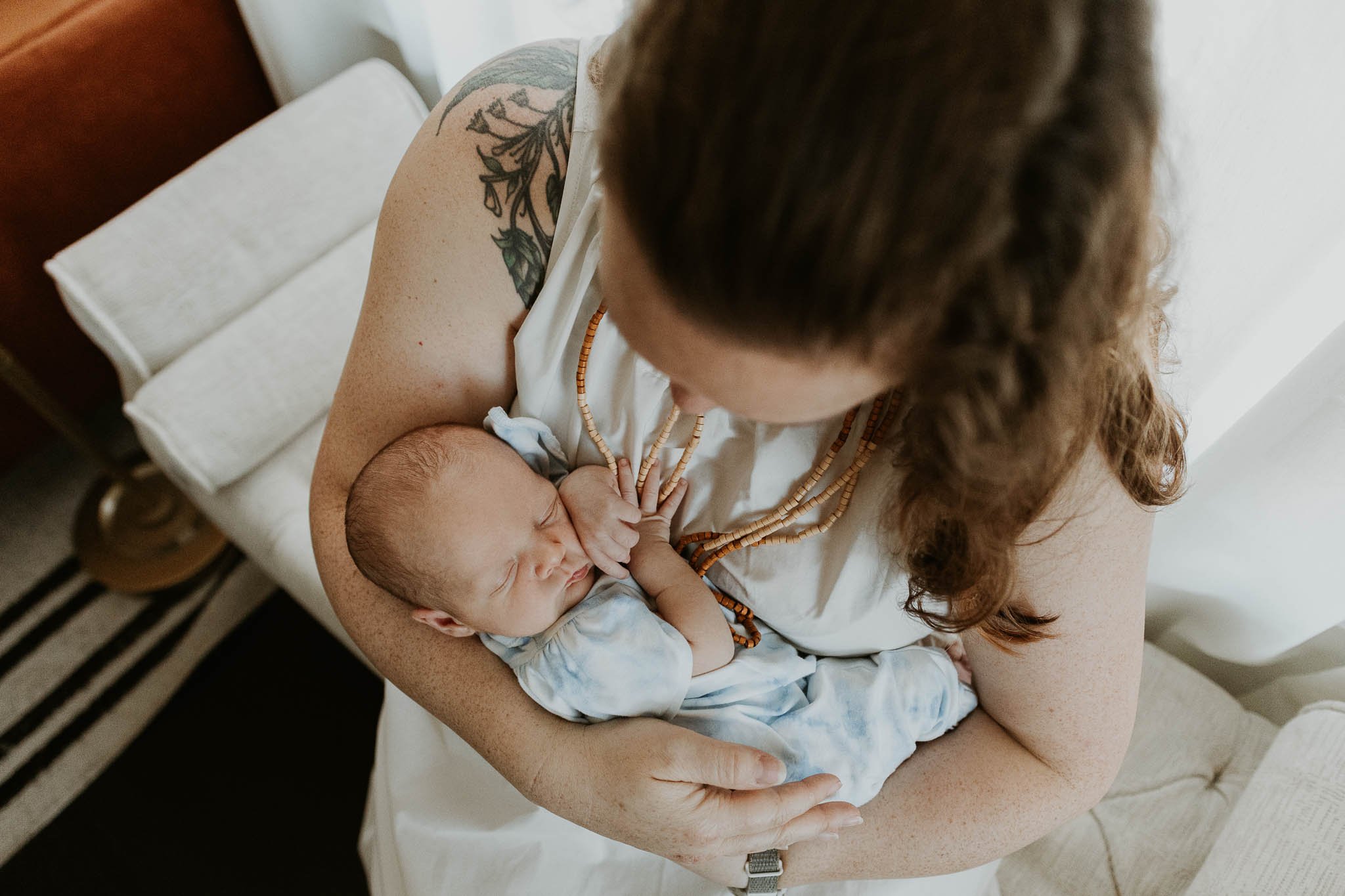 Overhead shots of baby with a parent is one of many detail shots Liz Walsh captures during a newborn photoshoot.