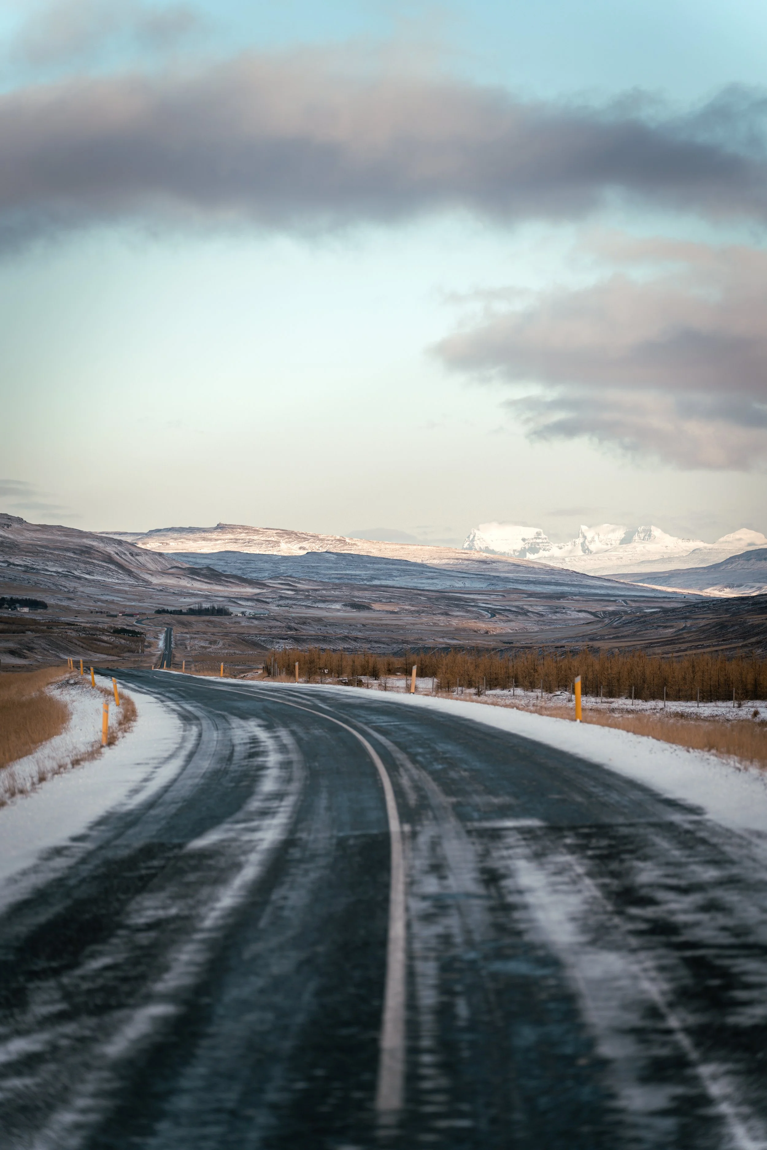 Icy road in Iceland with mountains in the background