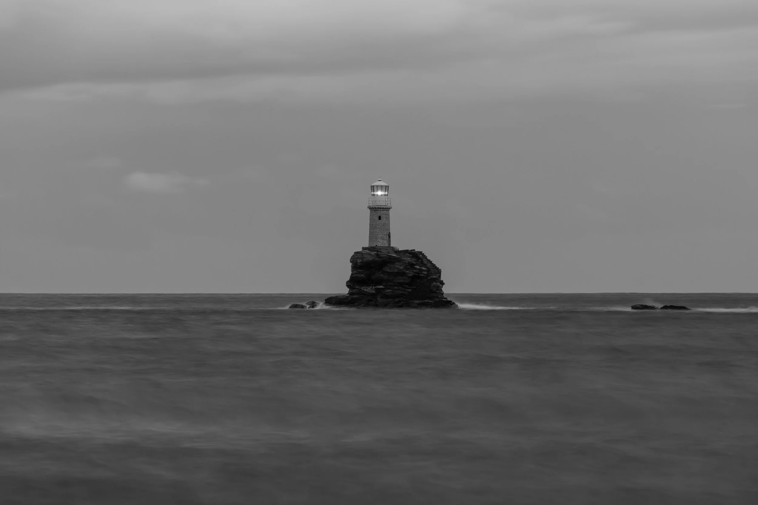 Tourlitis Lighthouse in located in Greek island of Andros, in a black and white photography