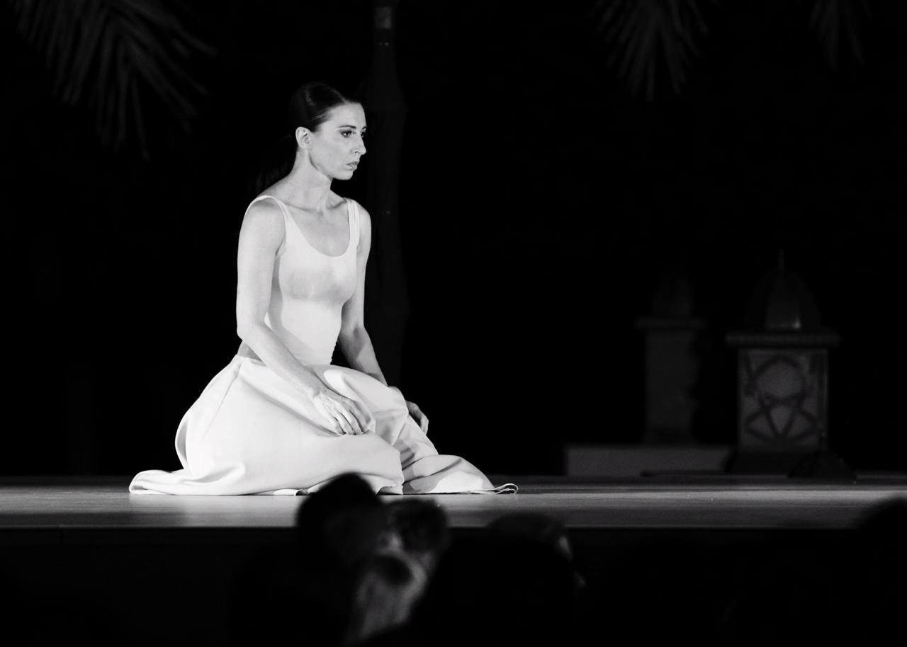 Mara knelt on stage black and white.JPG