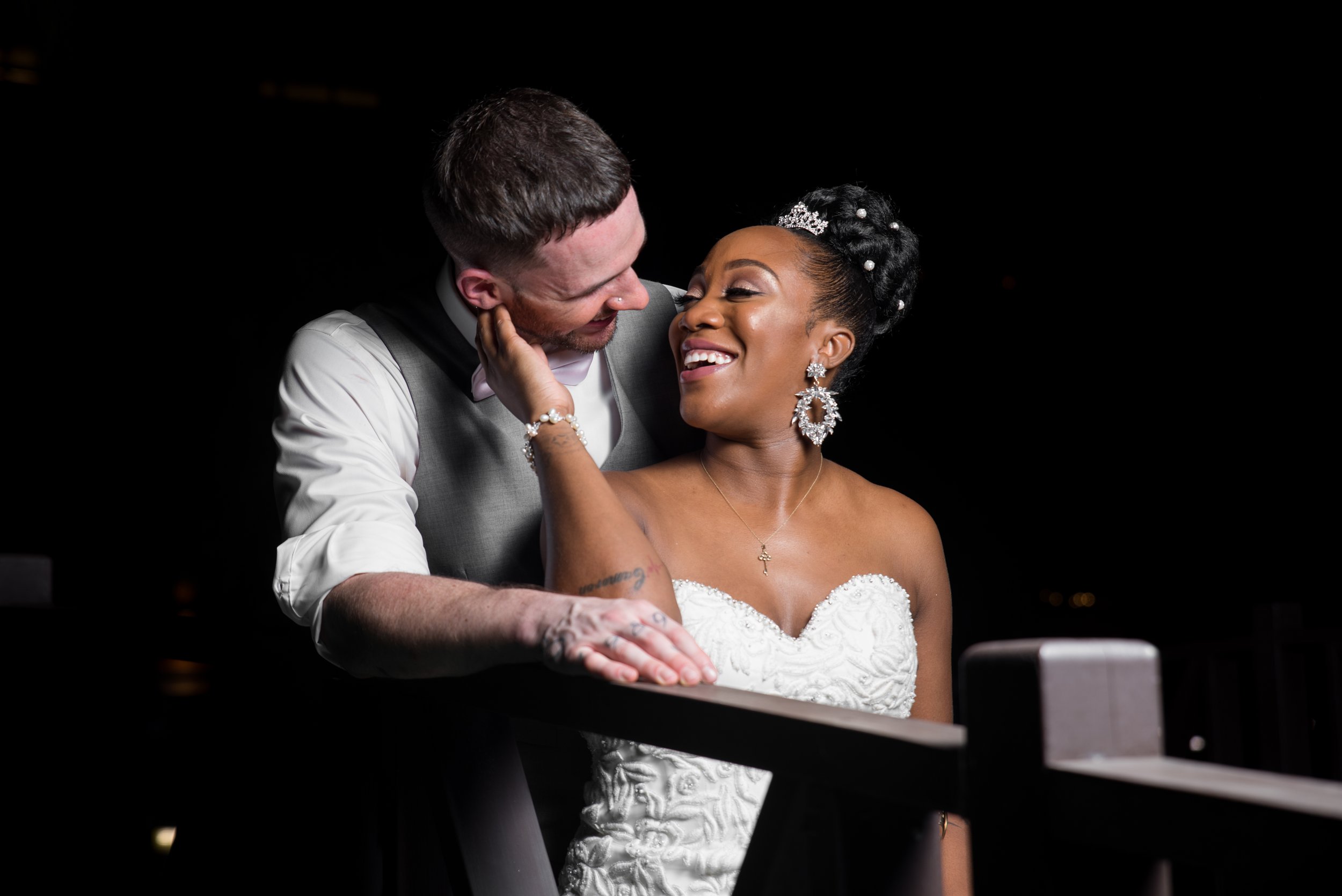 Laurie’s customers, Mariana and Carmen holding hands on a green lawn on their wedding day.