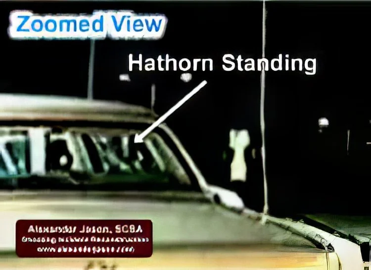 Hathorn is standing again, aiming and firing as the suspect moves away.