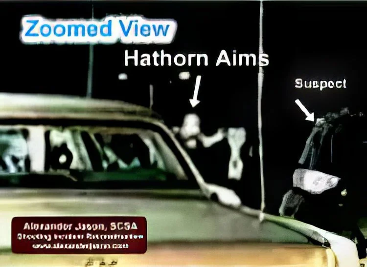 The suspect has broken away from the other officer. Hathorn rises up.